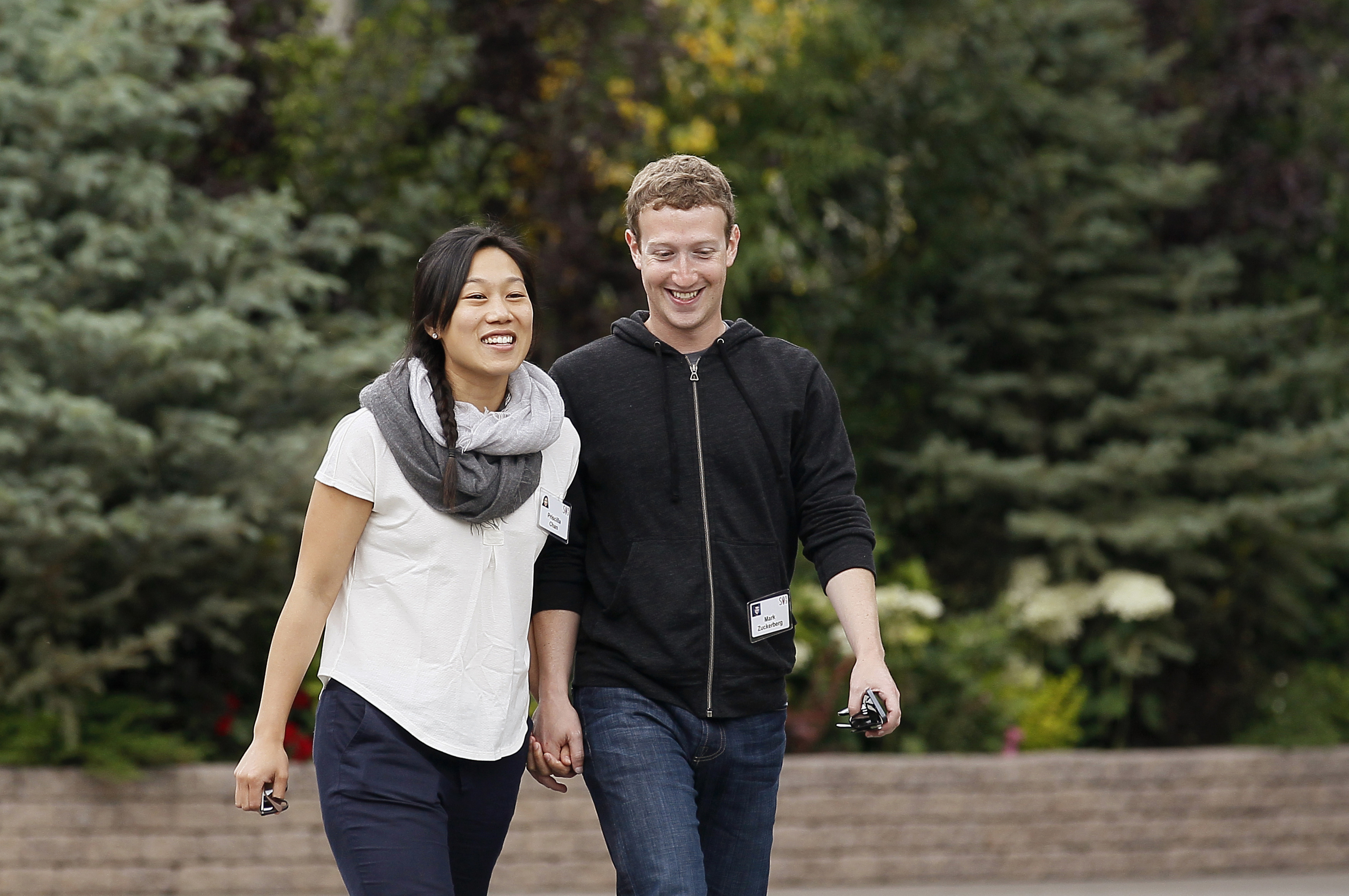 Facebook CEO Mark Zuckerberg walks with his wife Priscilla Chan at the annual Allen and Co. conference at the Sun Valley, Idaho Resort on July 11, 2013. (Rick Wilking—Reuters)