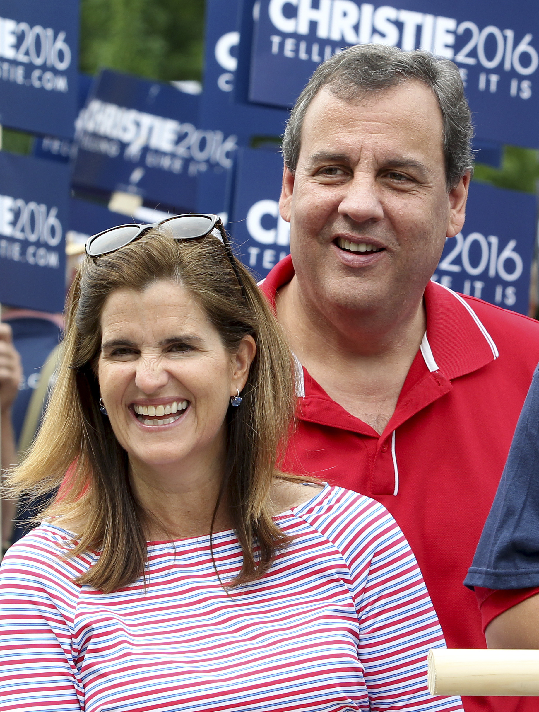 Republican presidential candidate New Jersey Gov. Chris Christie and his wife wife Mary Pat walk in the Fourth of July parade  in Wolfeboro, N.H. (Mary Schwalm—AP)