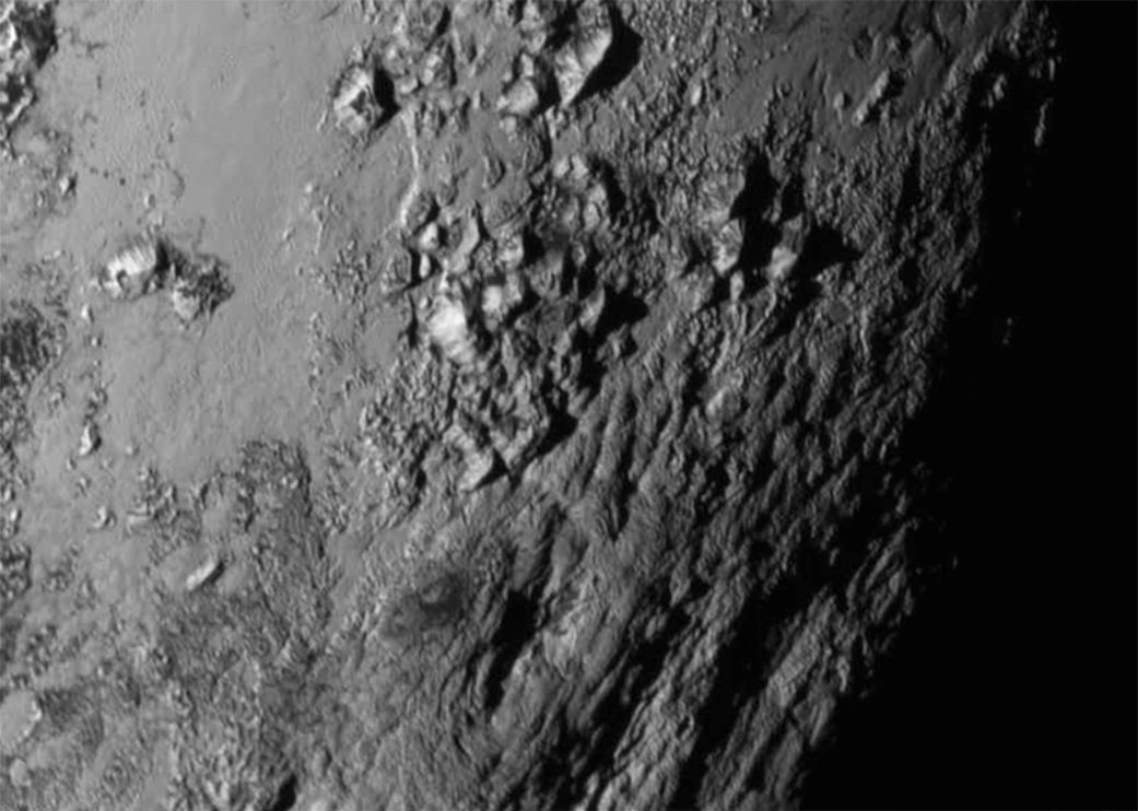Detailed photograph of an icy mountain range on Pluto's surface.