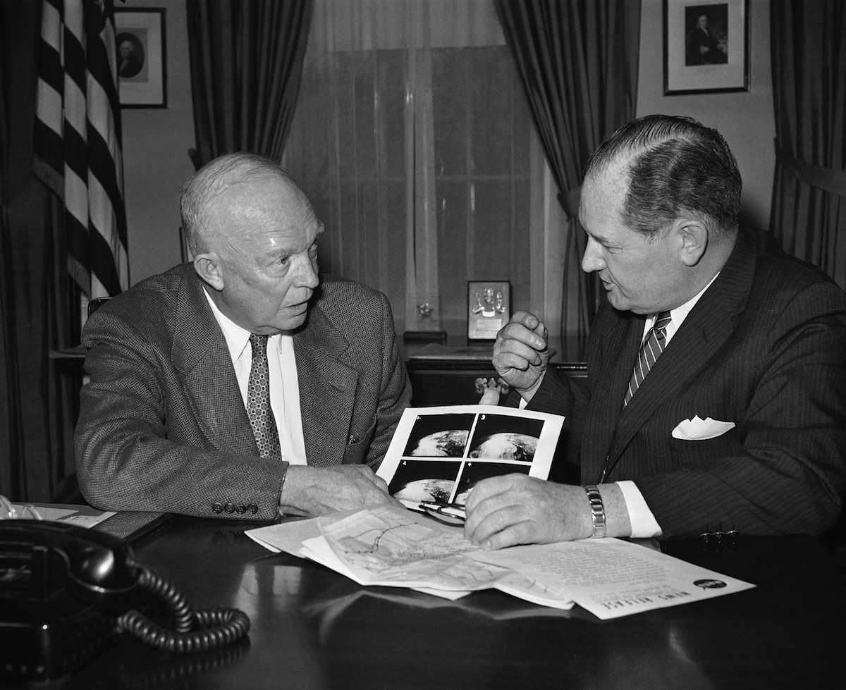 President Dwight Eisenhower and Dr. T. Keith Glennan, the first head of NASA, discuss photos received from the satellite Tires I in Washington on April 1, 1960, (AP)