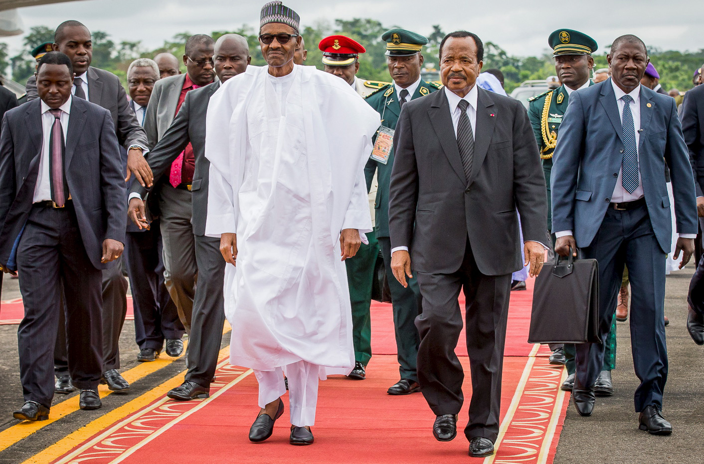 Nigeria's President Muhammadu Buhari, left, walks on a red carpet with Cameroon's President Paul Biya, right, as he arrives on an official visit to Cameroon in Yaounde on July 29, 2015. (Bayo Omoboriowo—Reuters)