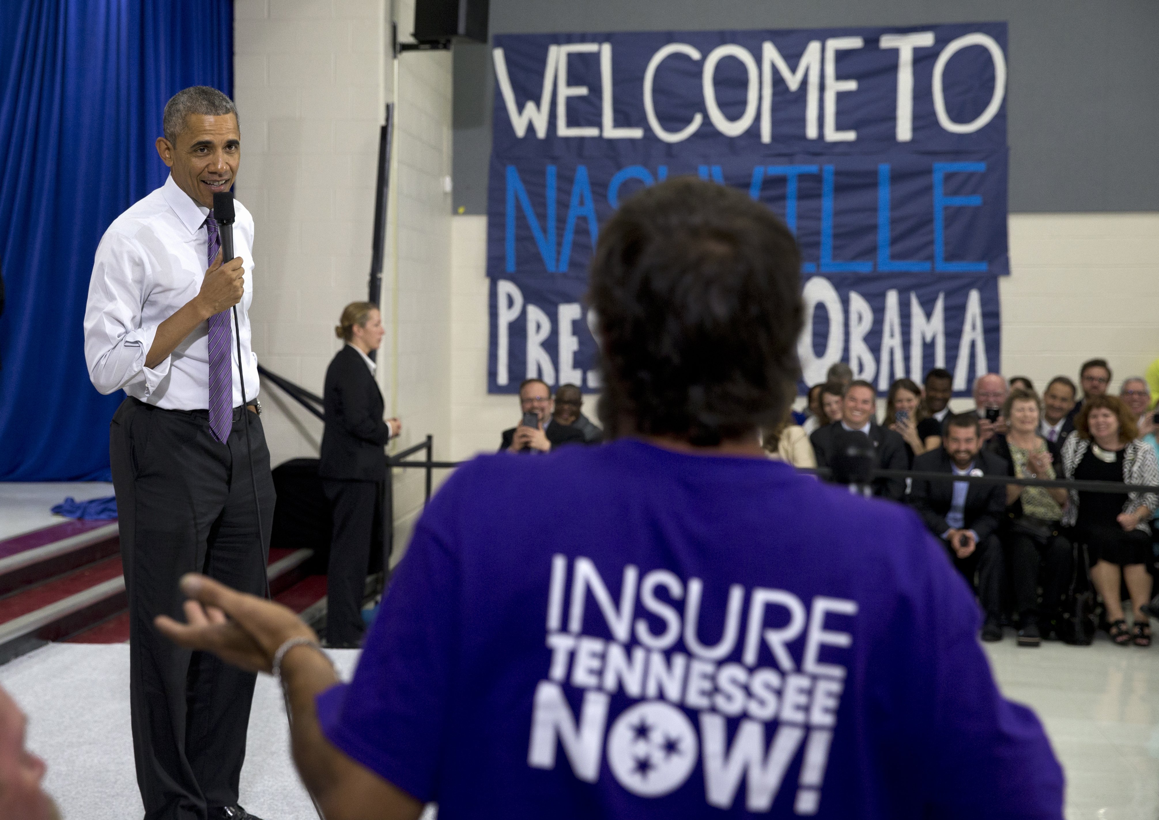 President Barack Obama talks to a man in the audience as he takes questions at Taylor Stratton Elementary School in Nashville on July 1, 2015, about the Affordable Care Act.