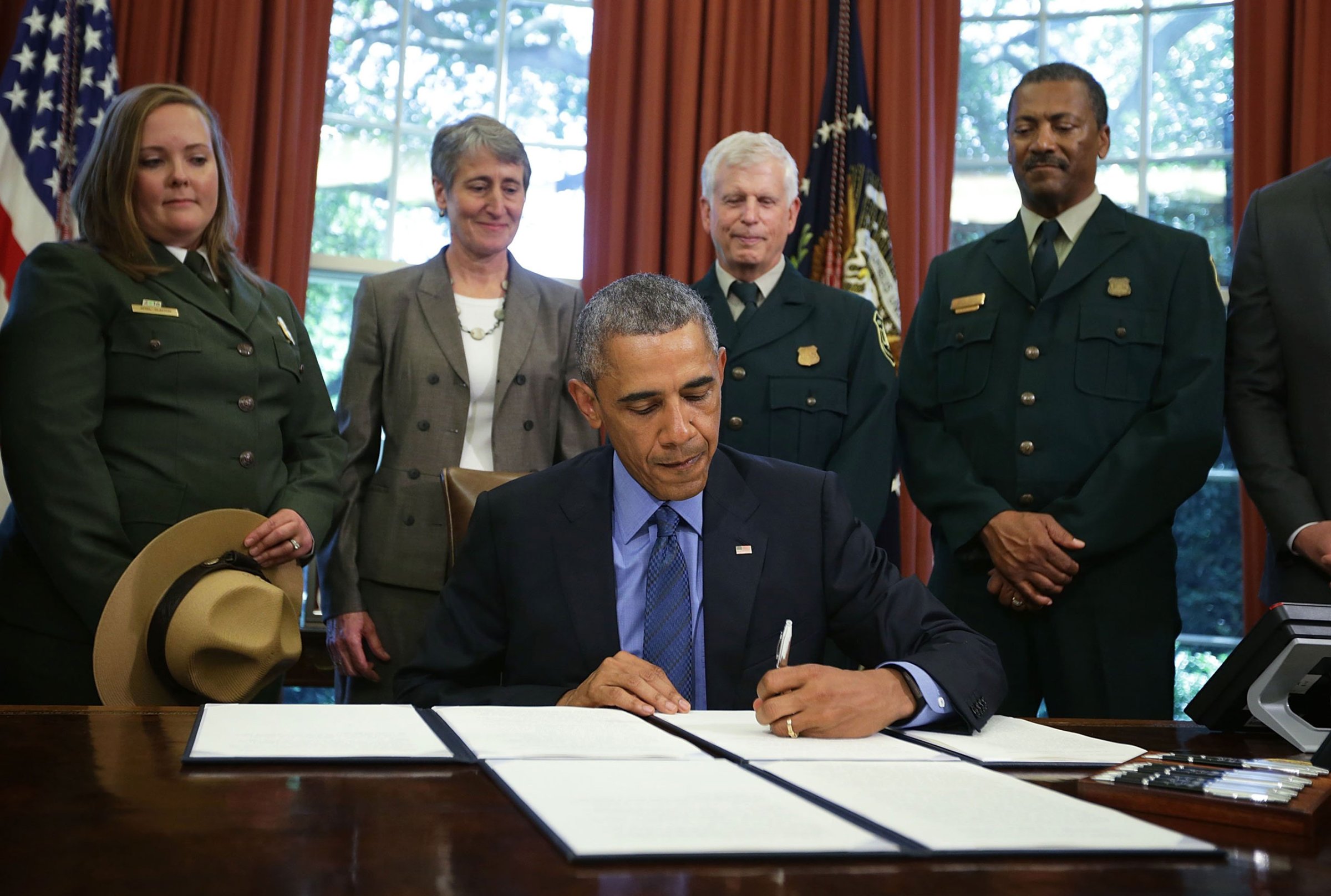 President Barack Obama signs proclamations to designate three new national monuments as Secretary of Interior Sally Jewell (2nd L) looks on in the Oval Office of the White House July 10, 2015 in Washington, DC. President Obama has designated three new national monuments of Berryessa Snow Mountain in California; Waco Mammoth in Texas; and the Basin and Range in Nevada. (Photo by Alex Wong/Getty Images)