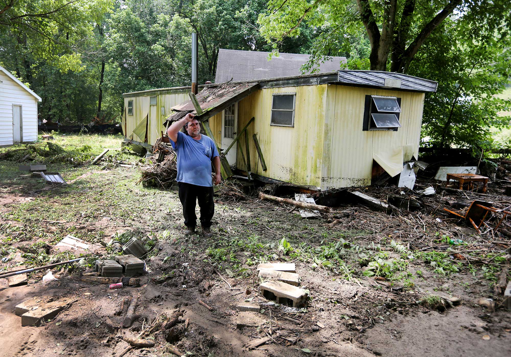 Jeff Downing walks around his property after severe flooding in Ripley, Ohio on July 19, 2015. (Liz Dufour—The Cincinnati Enquirer/AP)