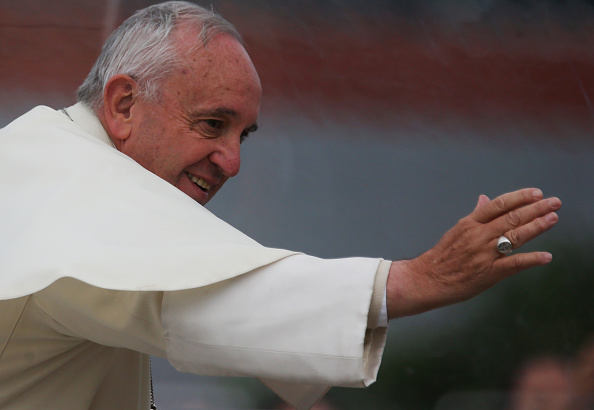 Pope Francis waves to the crowd from the Popemobile while making his way to celebrate an open-air Mass on July 9, 2015 in Santa Cruz, Bolivia.