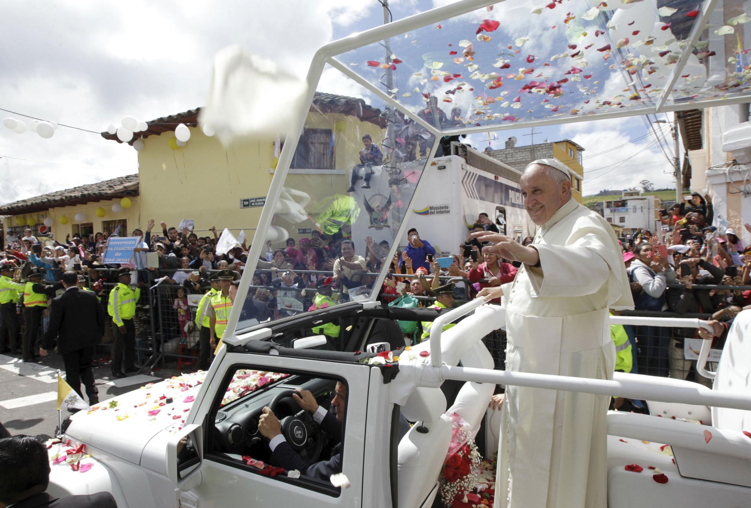 Pope Francis waves to the faithful from a popemobile in El Quinche, Ecuador, July 8, 2015. Pope Francis on Tuesday said protecting the planet was no longer a choice but a duty and called for a new "social justice" where access to the earth's resources would be based on equality instead of economic interests. REUTERS/Guillermo Granja