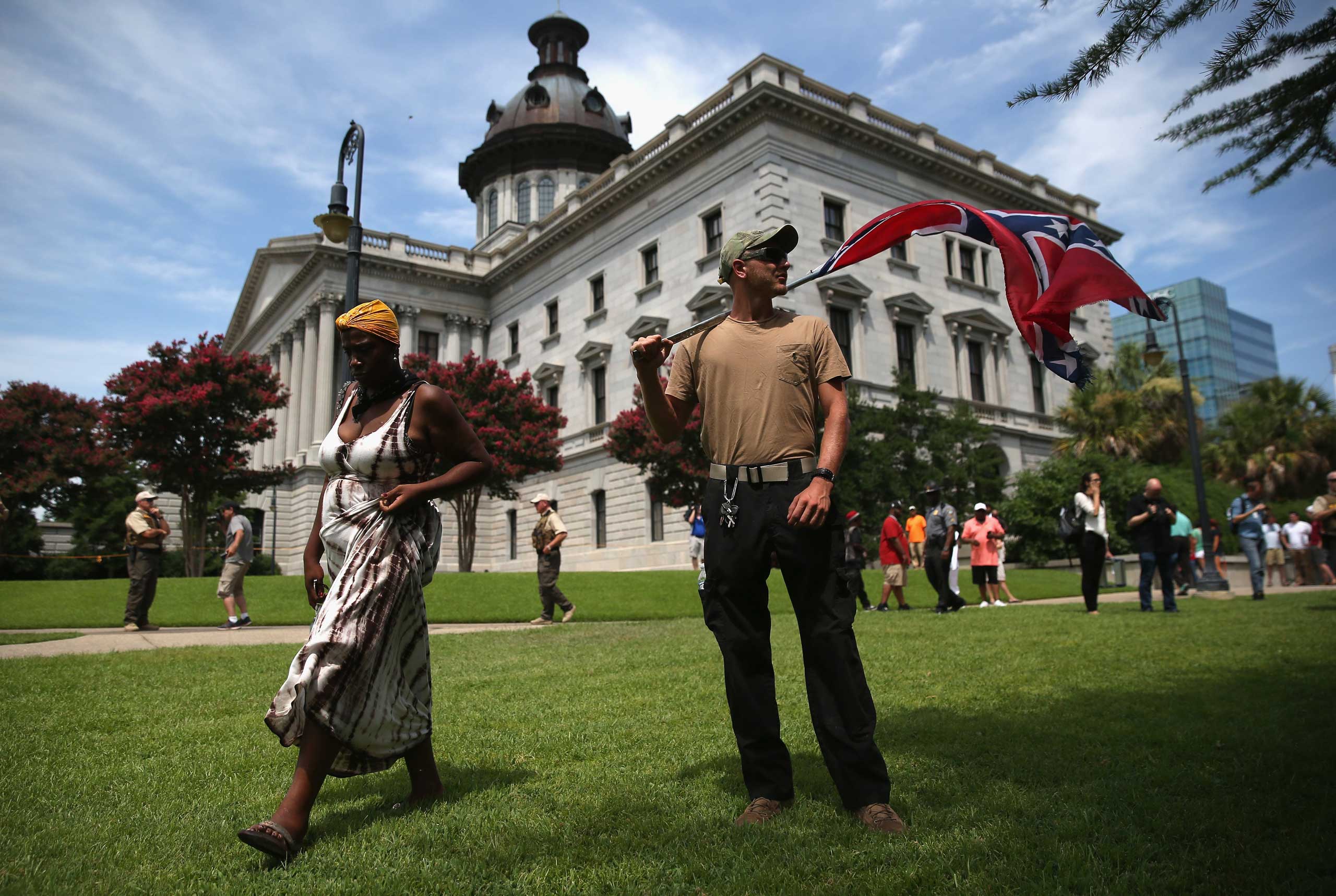 A man holds a Confederate flag on the state house grounds in Columbia, S.C. on July 18, 2015. (John Moore—Getty Images)