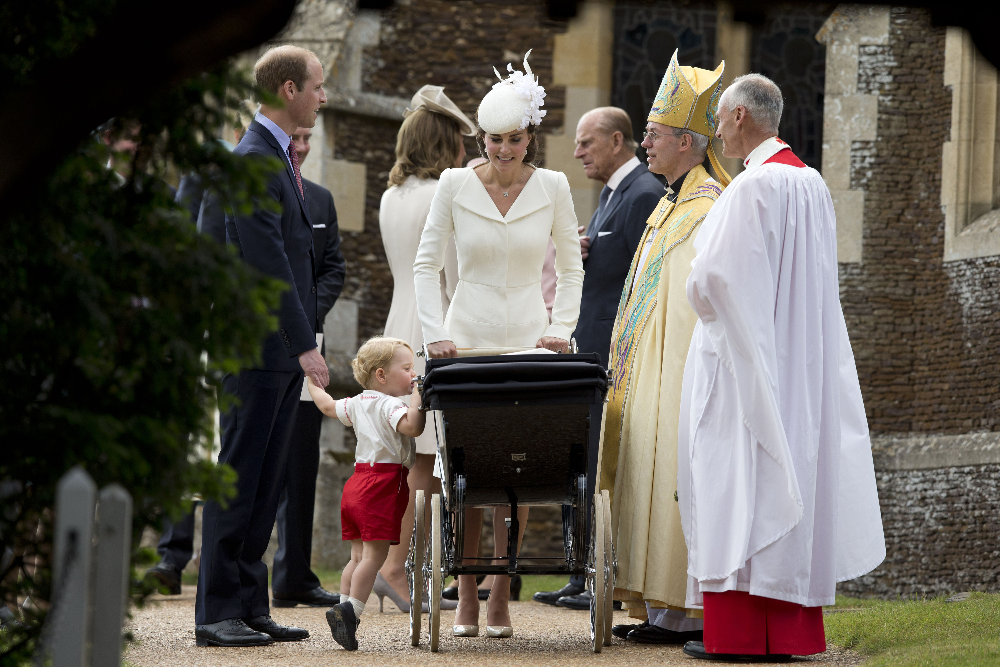 The Duke and Duchess of Cambridge with Prince George and Princess Charlotte with Archbishop of Canterbury Justin Welby (second right) as they leave the Church of St Mary Magdalene in Sandringham, England after Princess Charlotte's christening on July 5, 2015.