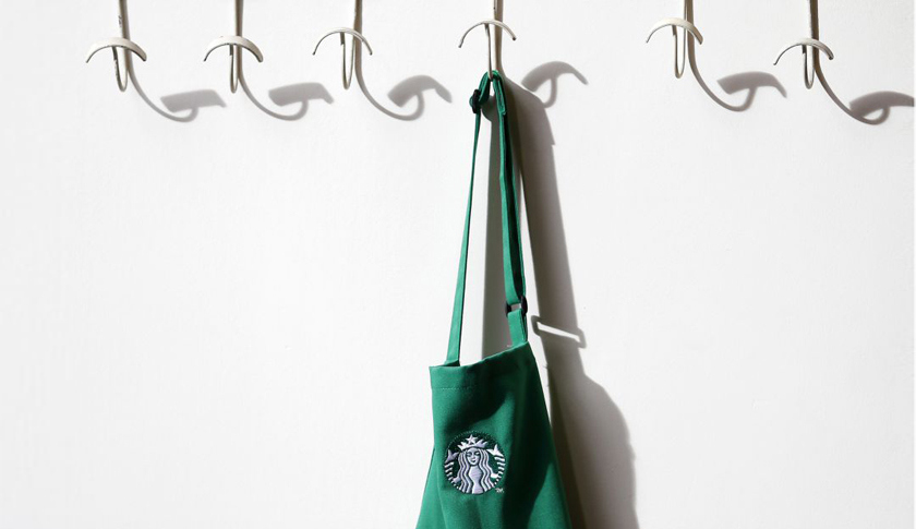 A barrista's apron hangs on a peg in Starbucks' Mayfair Vigo Street branch in central London