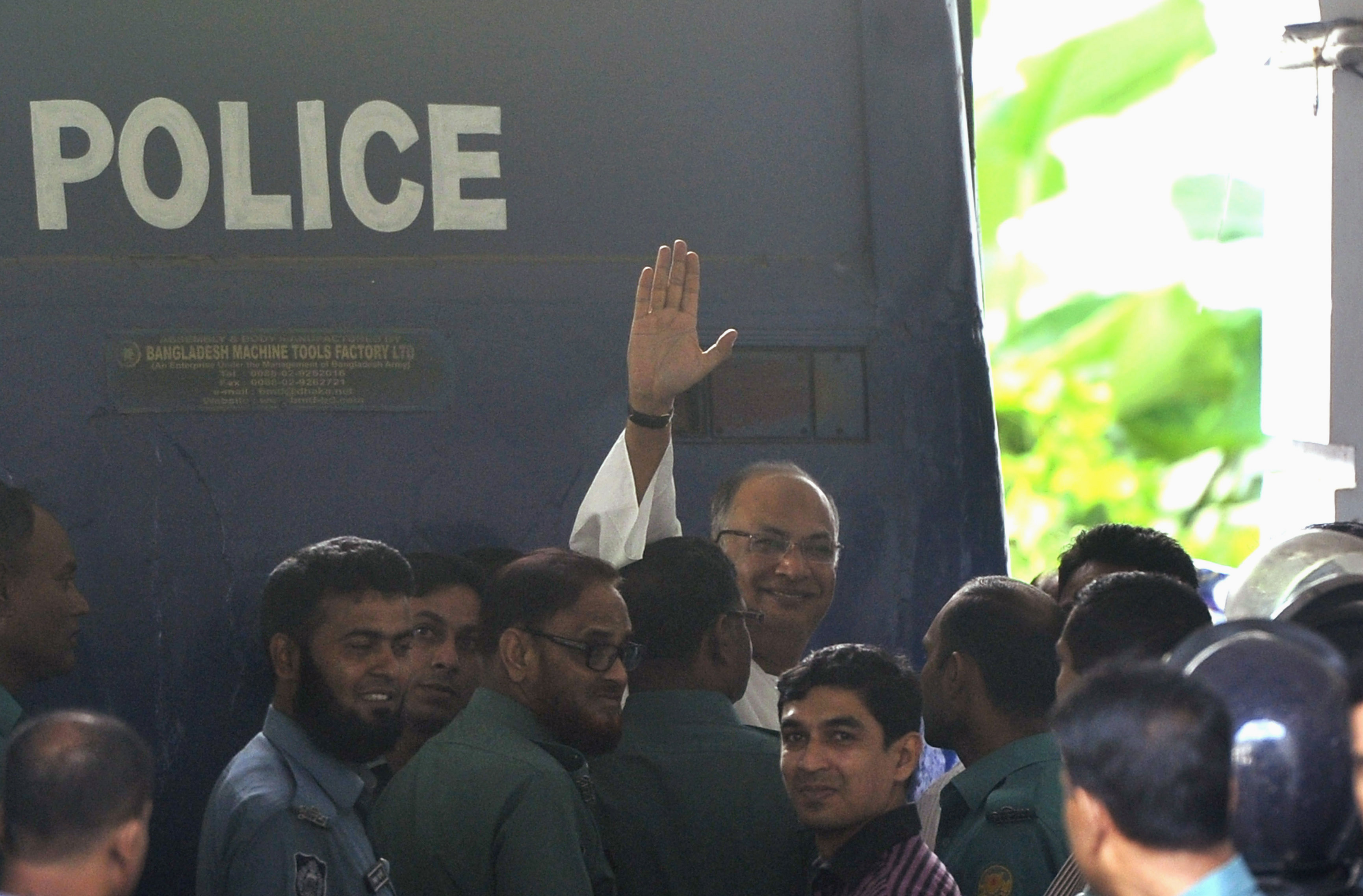 Salauddin Quader Chowdhury, a senior opposition leader waves to the media after he arrives to the war crime tribunal in Dhaka.