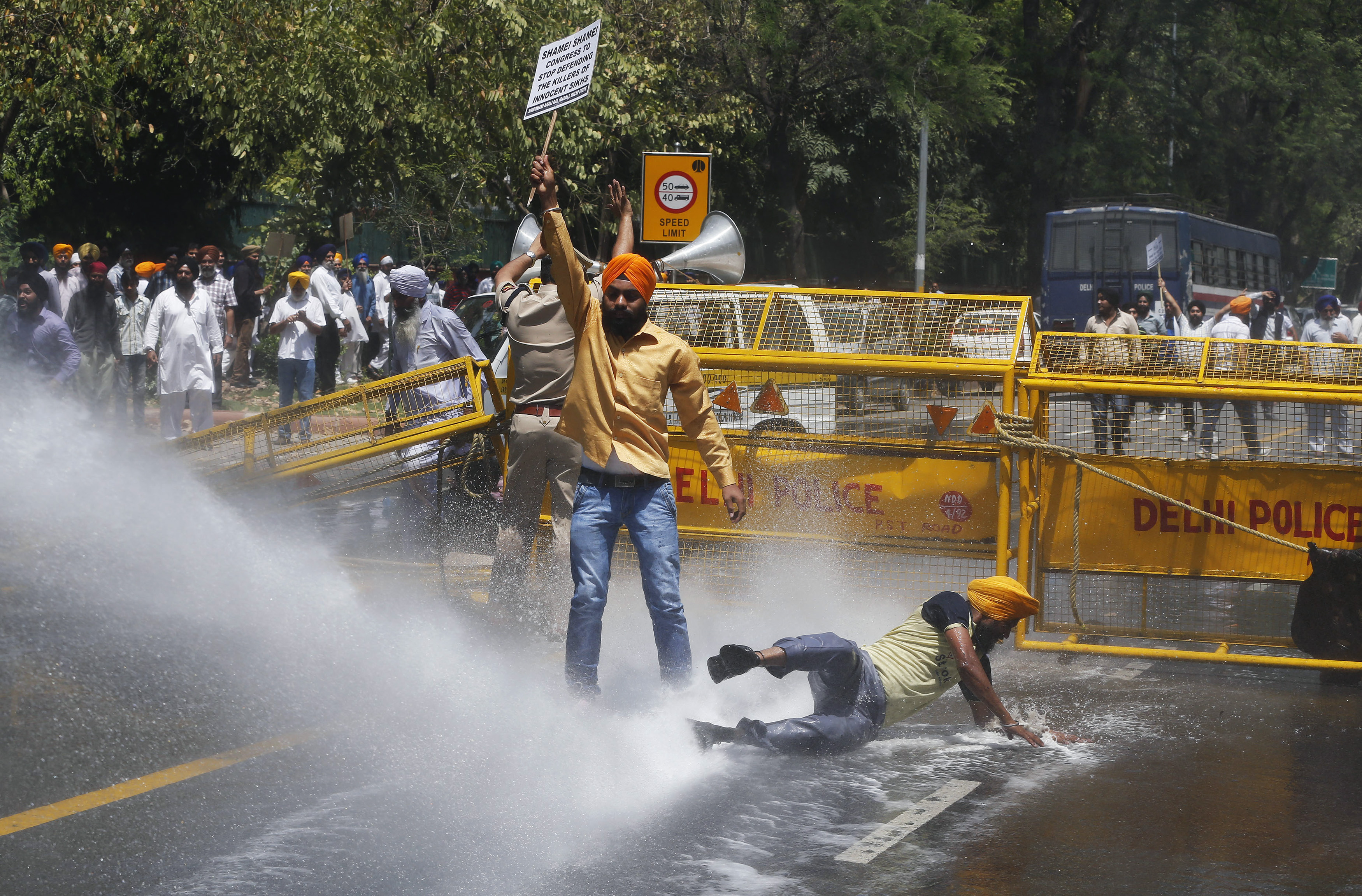 Police use a water cannon to disperse Sikh protesters during a demonstration in front of India?s ruling Congress party headquarters in New Delhi