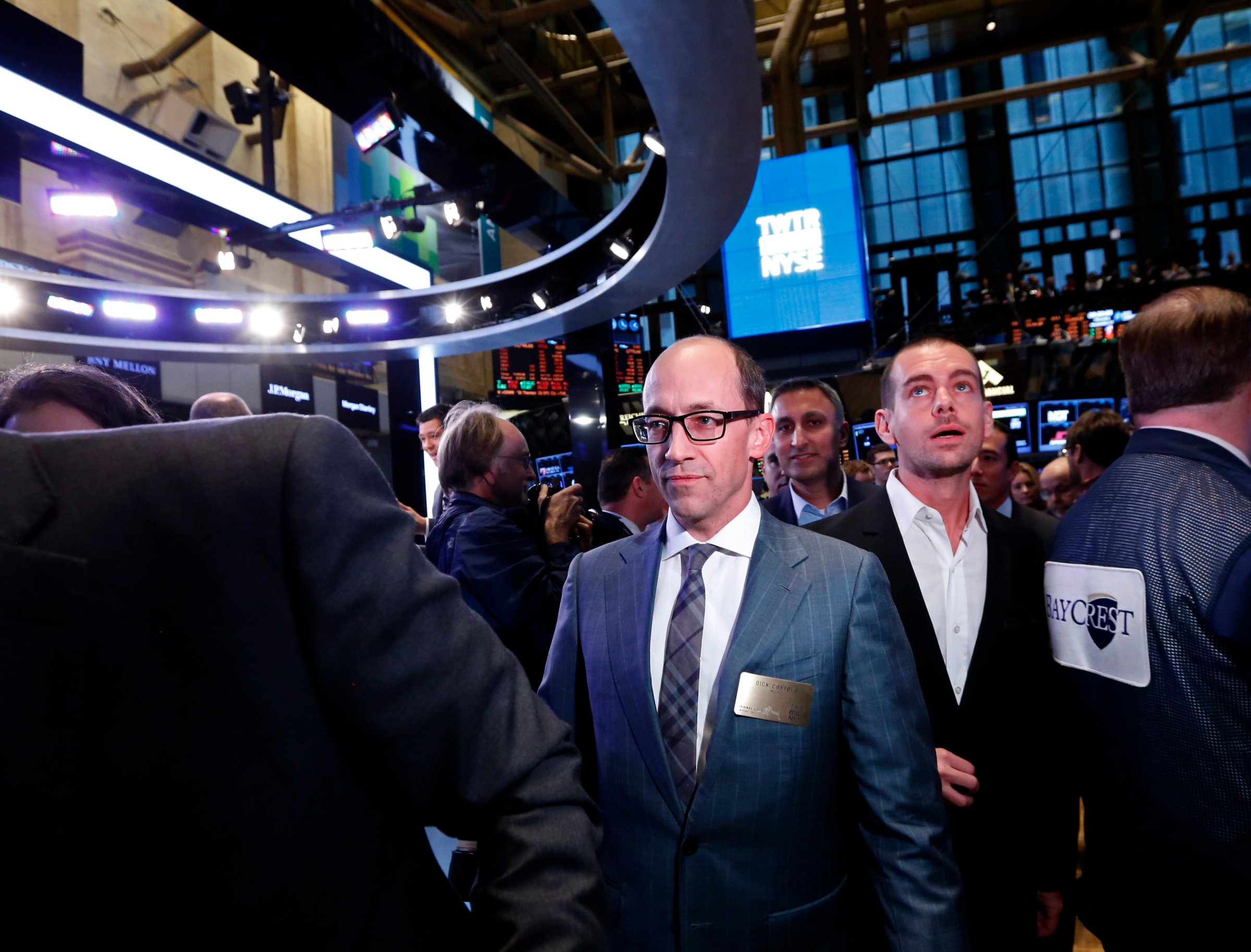 Twitter CEO Costolo and Twitter co-founder Dorsey walk the floor of the New York Stock Exchange during Twitter's IPO in New York