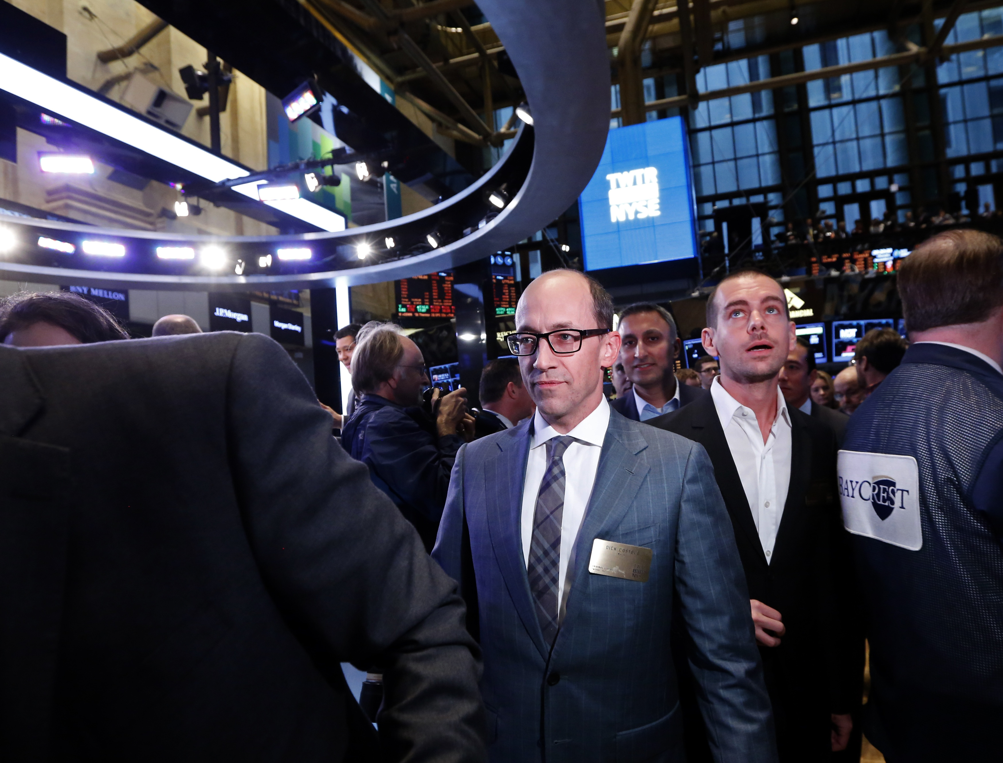 Twitter CEO Costolo and Twitter co-founder Dorsey walk the floor of the New York Stock Exchange during Twitter's IPO in New York