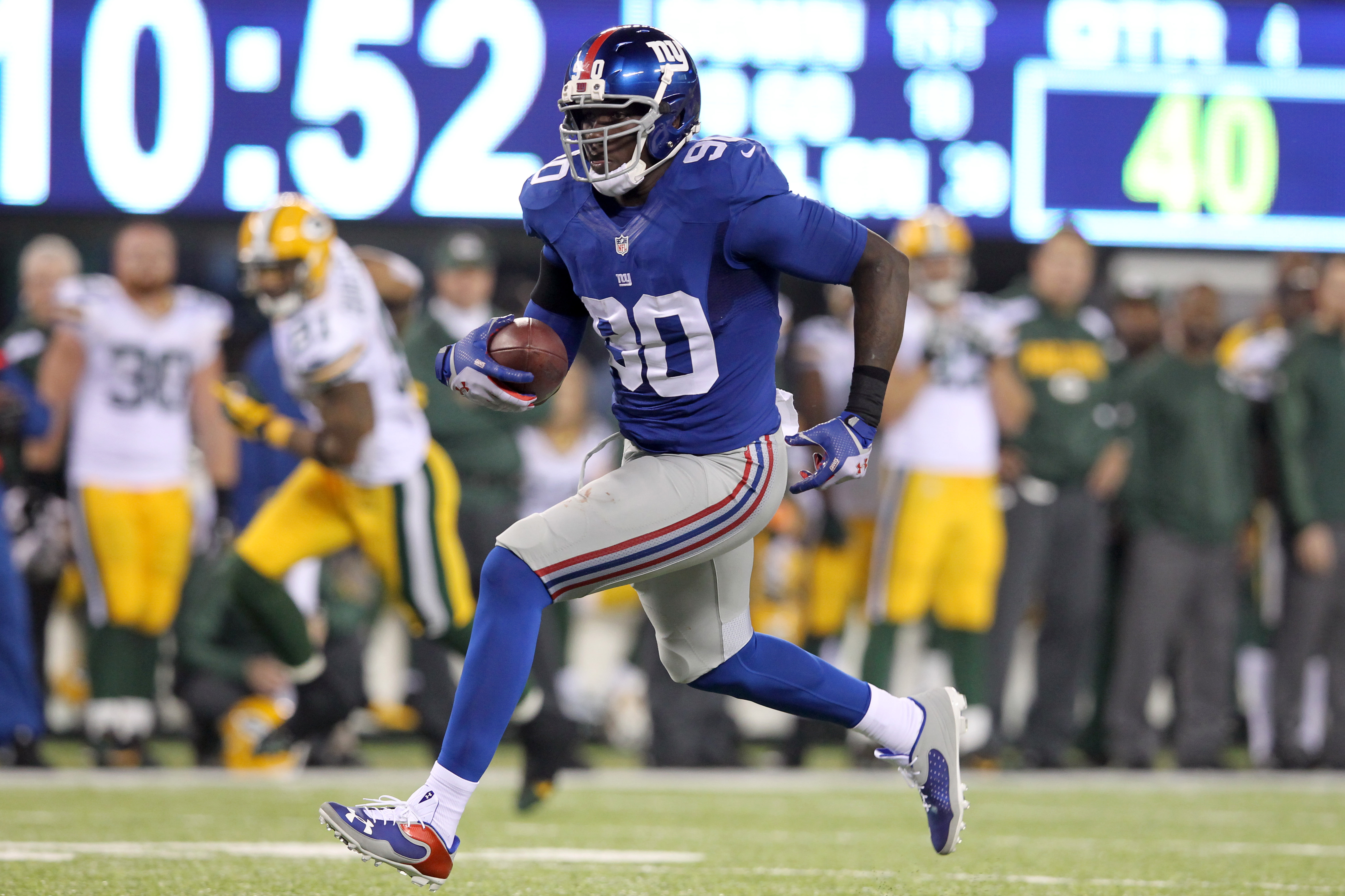 New York Giants defensive end Jason Pierre-Paul runs back an interception against the Green Bay Packers for a touchdown during the fourth quarter of a game at MetLife Stadium on November 17, 2013. (Reuters/USA Today Sports—Brad Penner)
