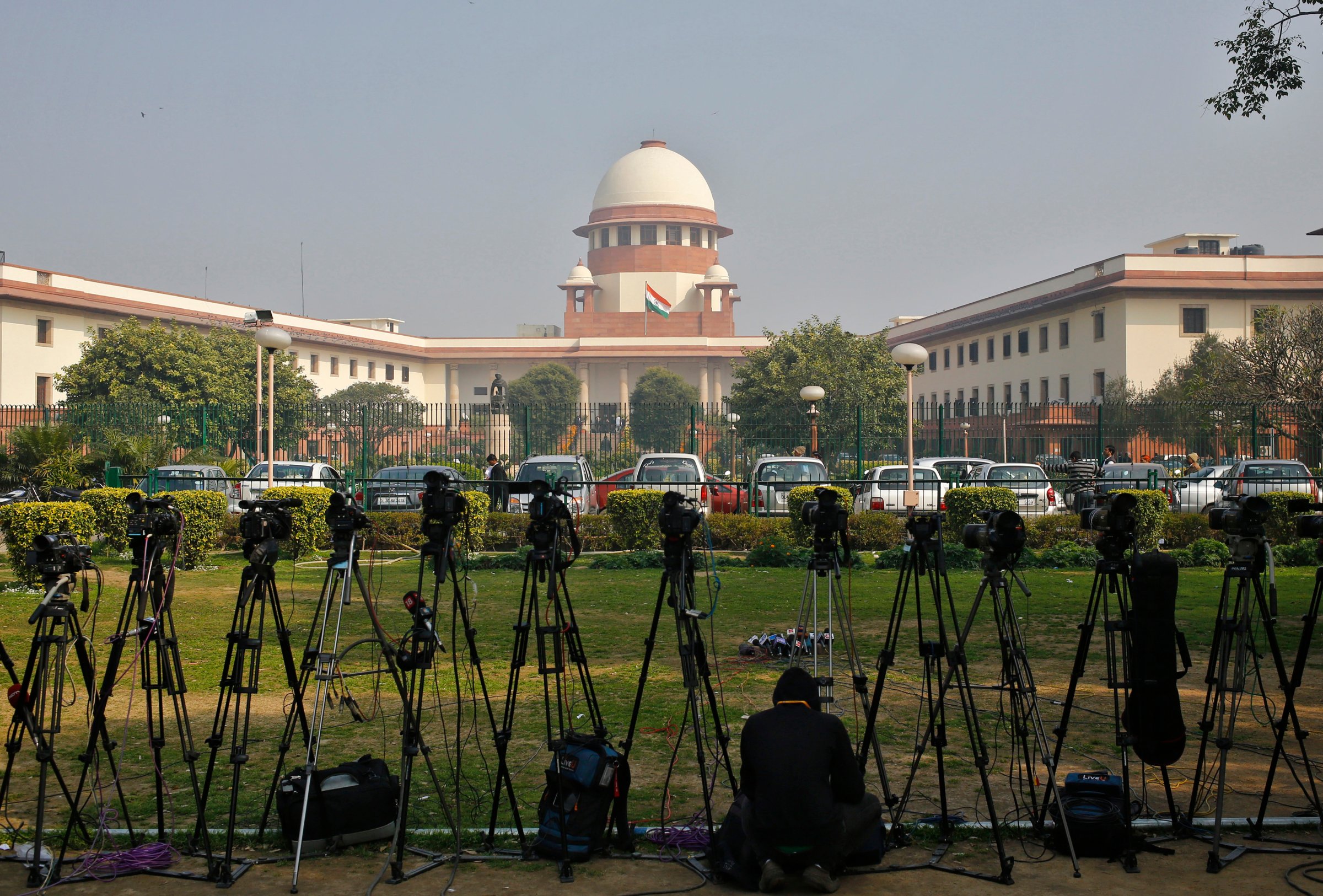 A television journalist sets his camera inside the premises of the Supreme Court in New Delhi