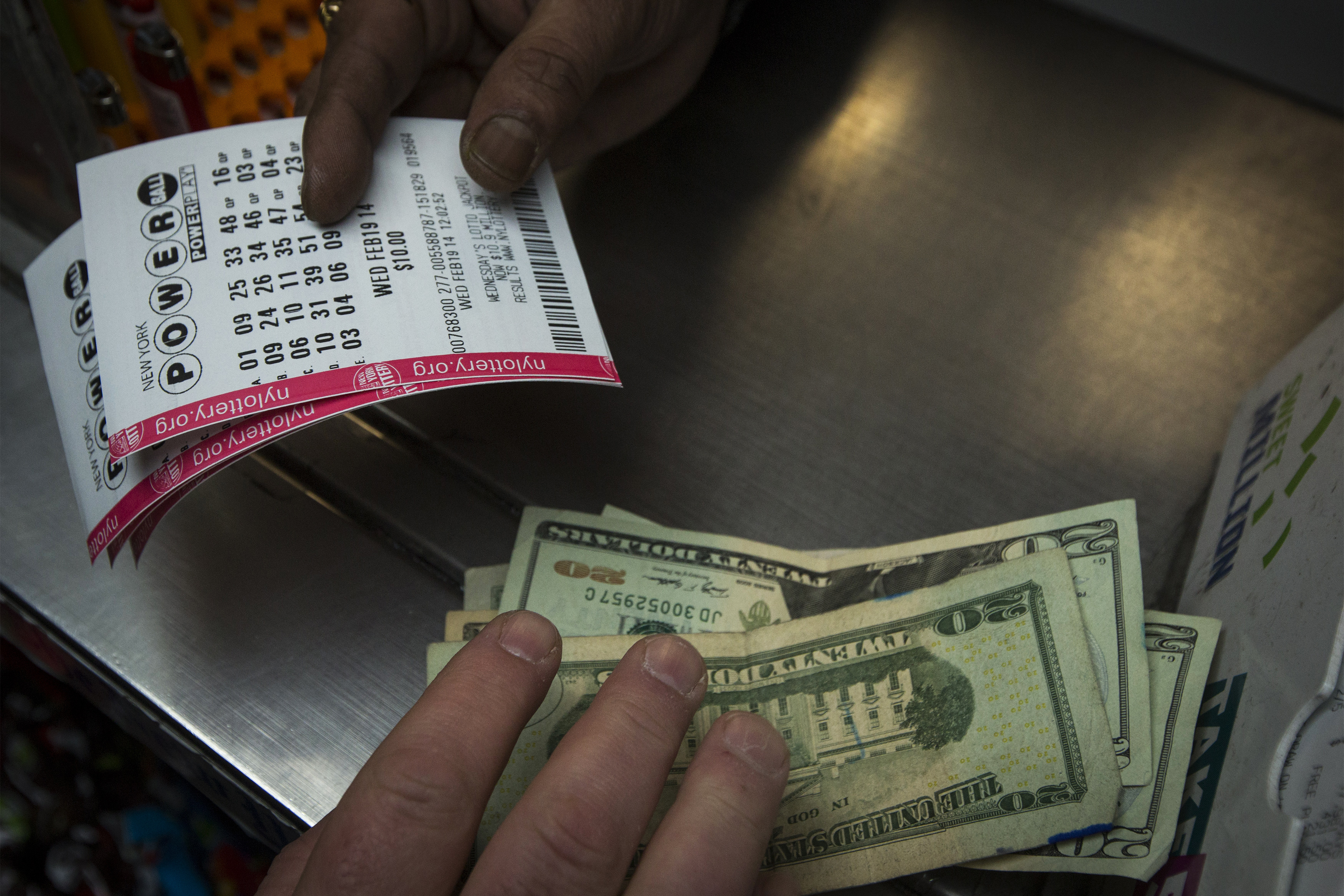 A man purchases New York State Lottery tickets for the $400 million Powerball lottery in New York's financial district
