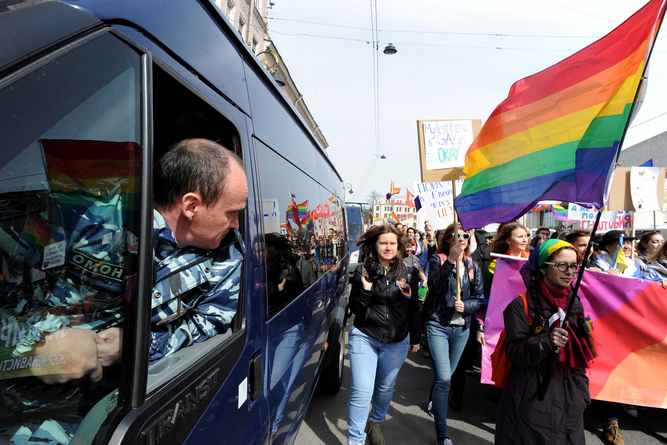 A policeman looks out from a truck as members and supporters of the LGBT community take part in a May Day rally in Saint Petersburg on May 1, 2015. (Olga Maltseva—AFP/Getty Images)