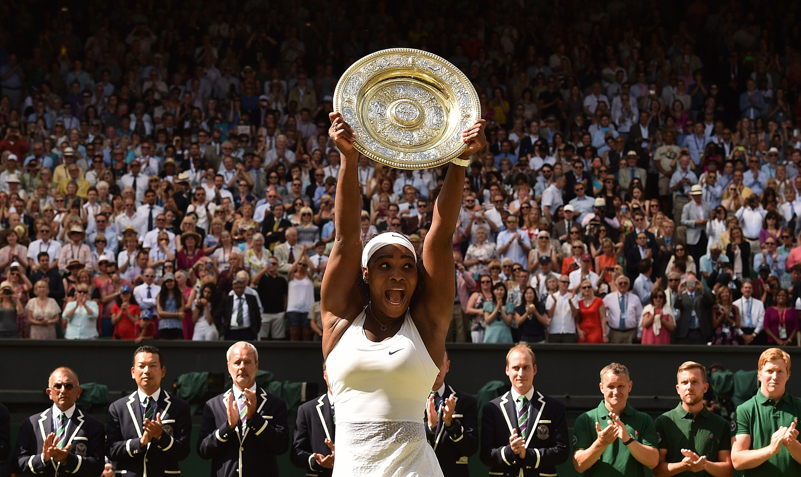 Serena Williams celebrates with the winner's trophy, the Venus Rosewater Dish, after her women's singles final victory over Spain's Garbine Muguruza on day twelve of the 2015 Wimbledon Championships at The All England Tennis Club in Wimbledon, southwest London on July 11, 2015. (Leon Neal—AFP/Getty Images)