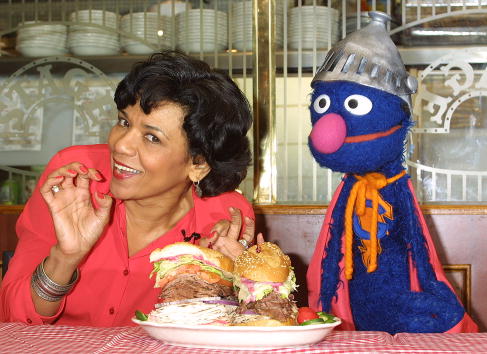 Sonia Manzano, who plays Maria Rodriquez on "Sesame Street," and the muppet Grover at an event in New York City on Feb. 27, 2002.