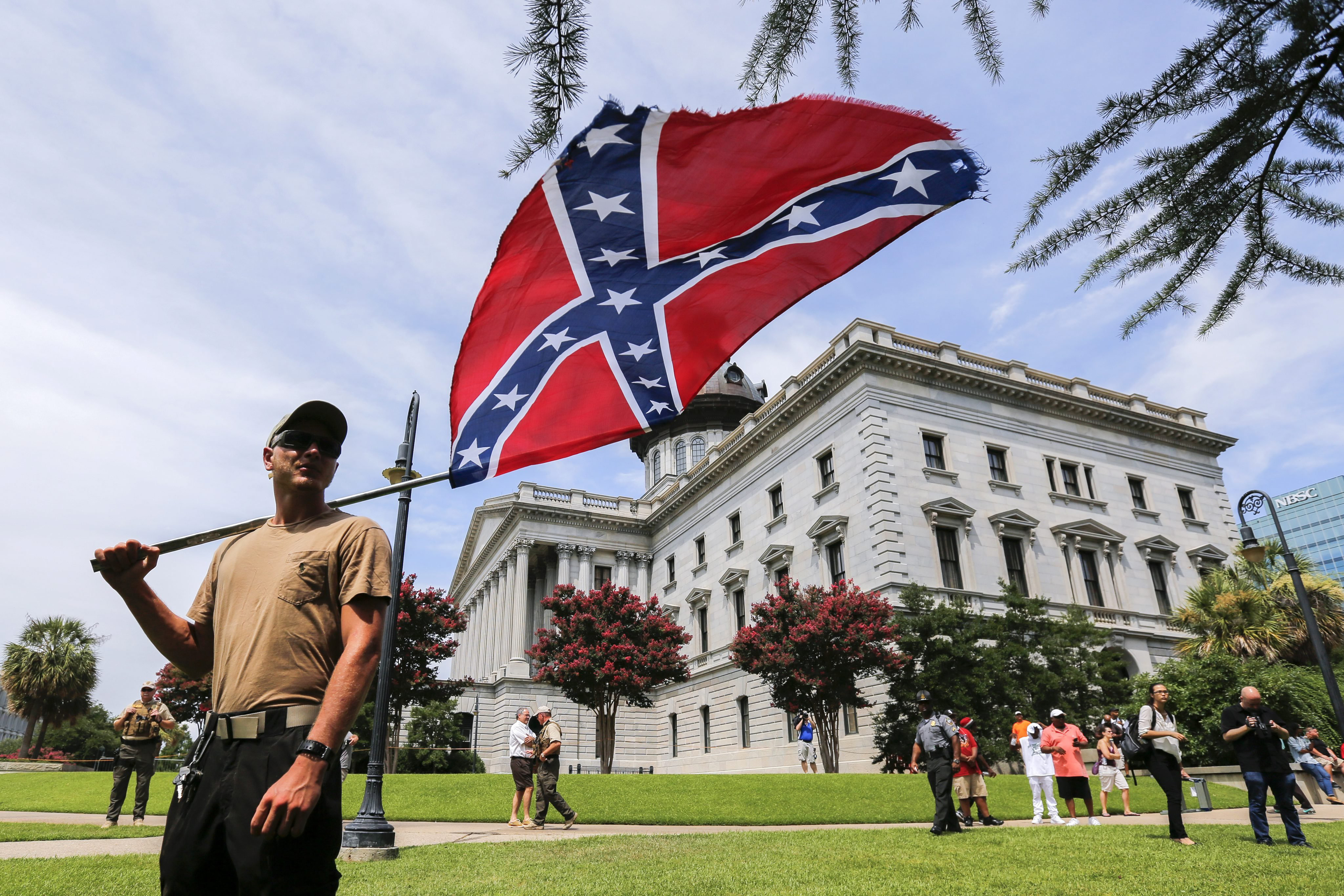 A man displays a Confederate battle flag during New Black Panther Party and Ku Klux Klan rallies on the grounds of the South Carolina Capitol in Columbia, S.C. on July 18, 2015. (Erik S. Lesser—EPA)