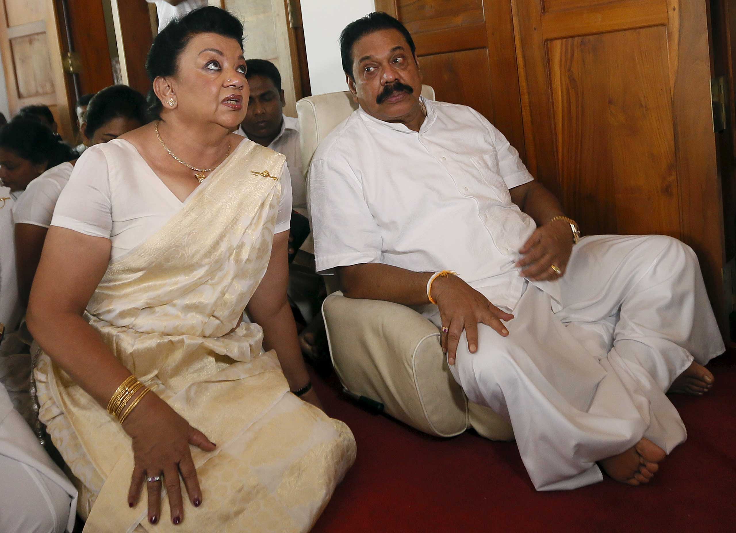 Former Sri Lankan president Mahinda Rajapaksa sits next to his wife Shiranthi Rajapaksa during a religious ceremony at his residence in Medamulana, Sri Lanka, on July 1, 2015. (Dinuka Liyanawatte—Reuters)