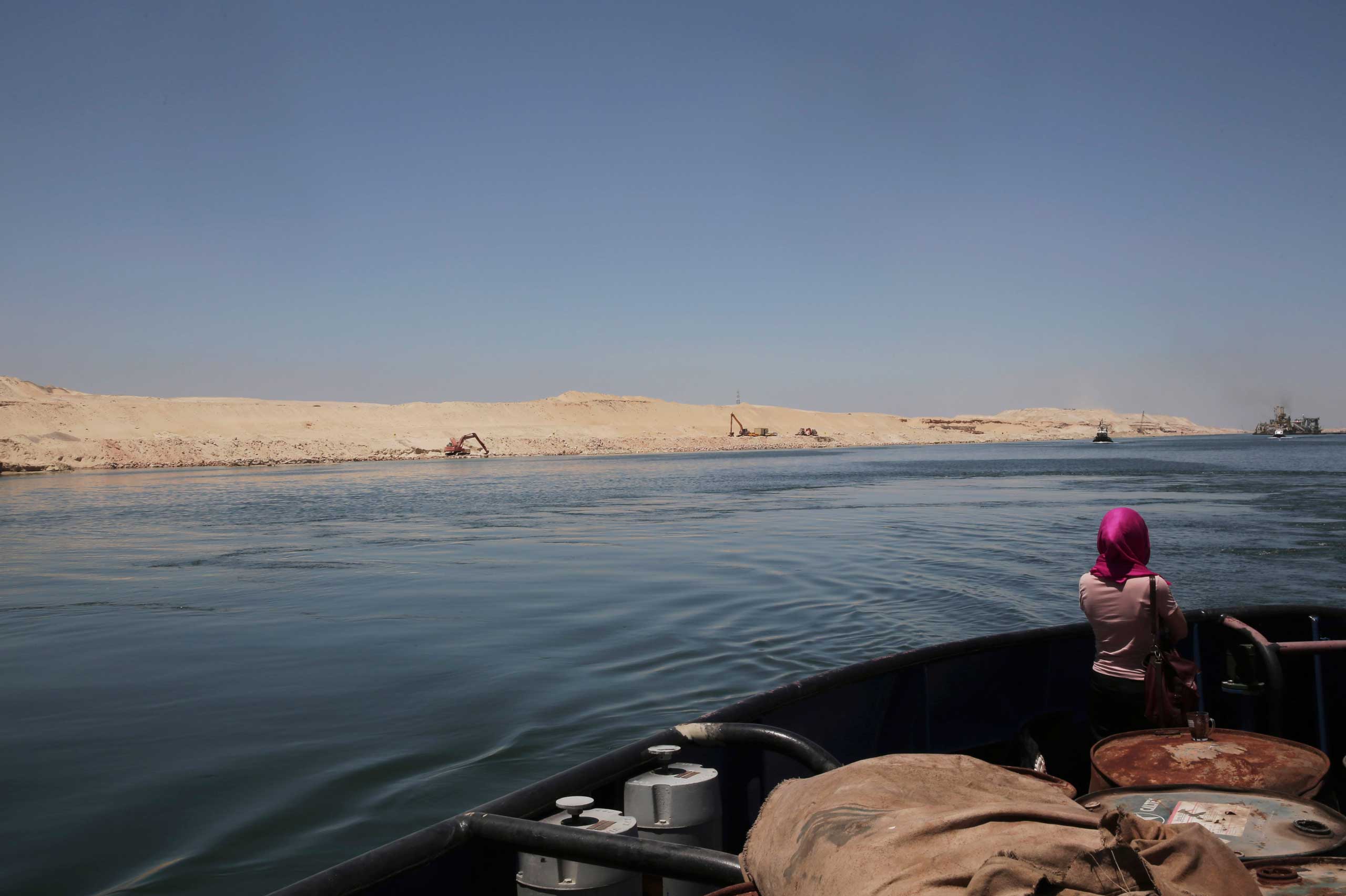 A woman looks at a new section of the Suez Canal during a media tour in Ismailia, Egypt, on July 29, 2015. (Nariman El-Mofty—AP)