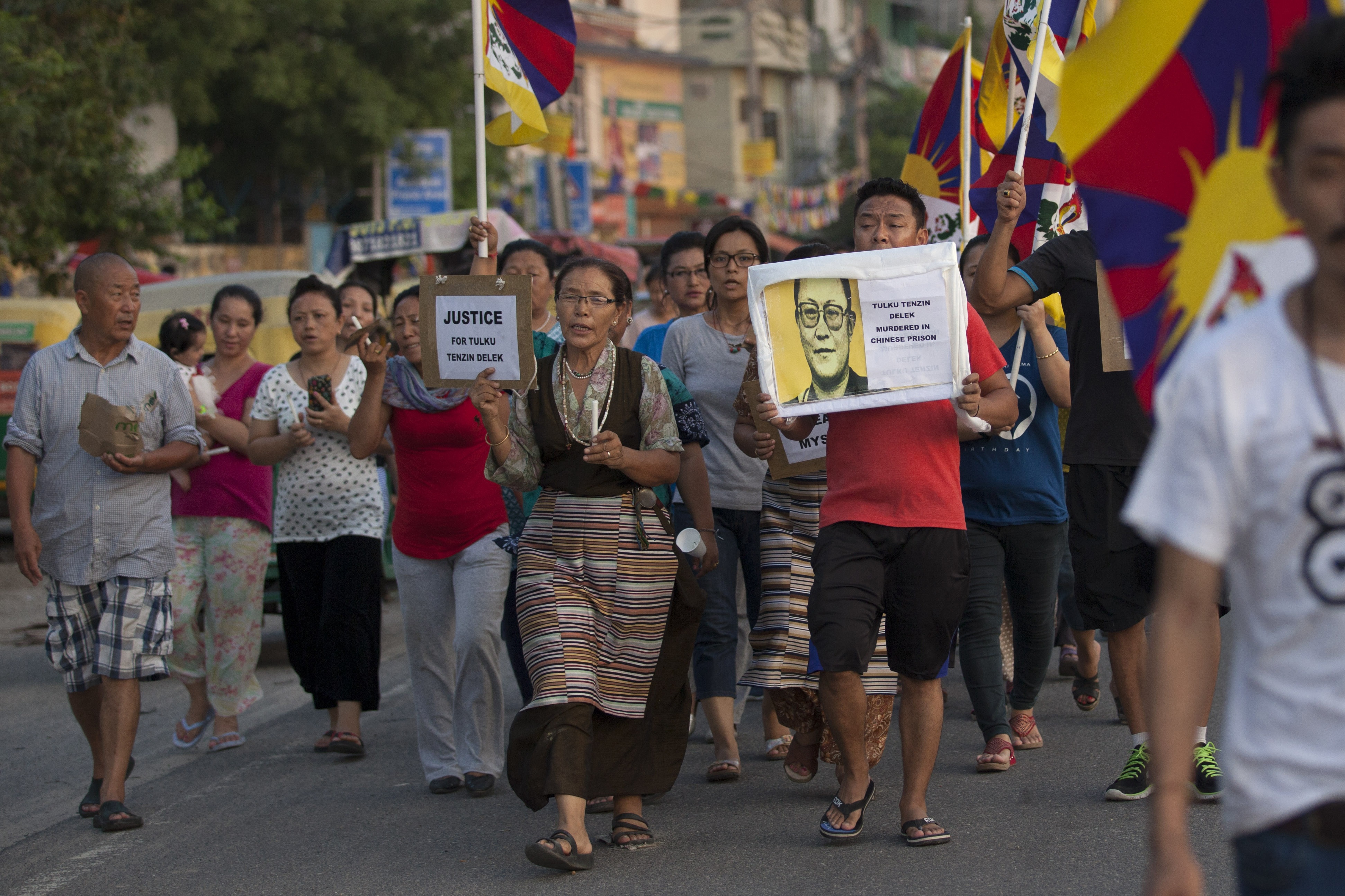 Exile Tibetans walk during a candle light vigil to remember Tibetan lama Tenzin Delek Rinpoche, in New Delhi, India, Monday, July 13, 2015. (Tsering Topgyal&mdash;AP)