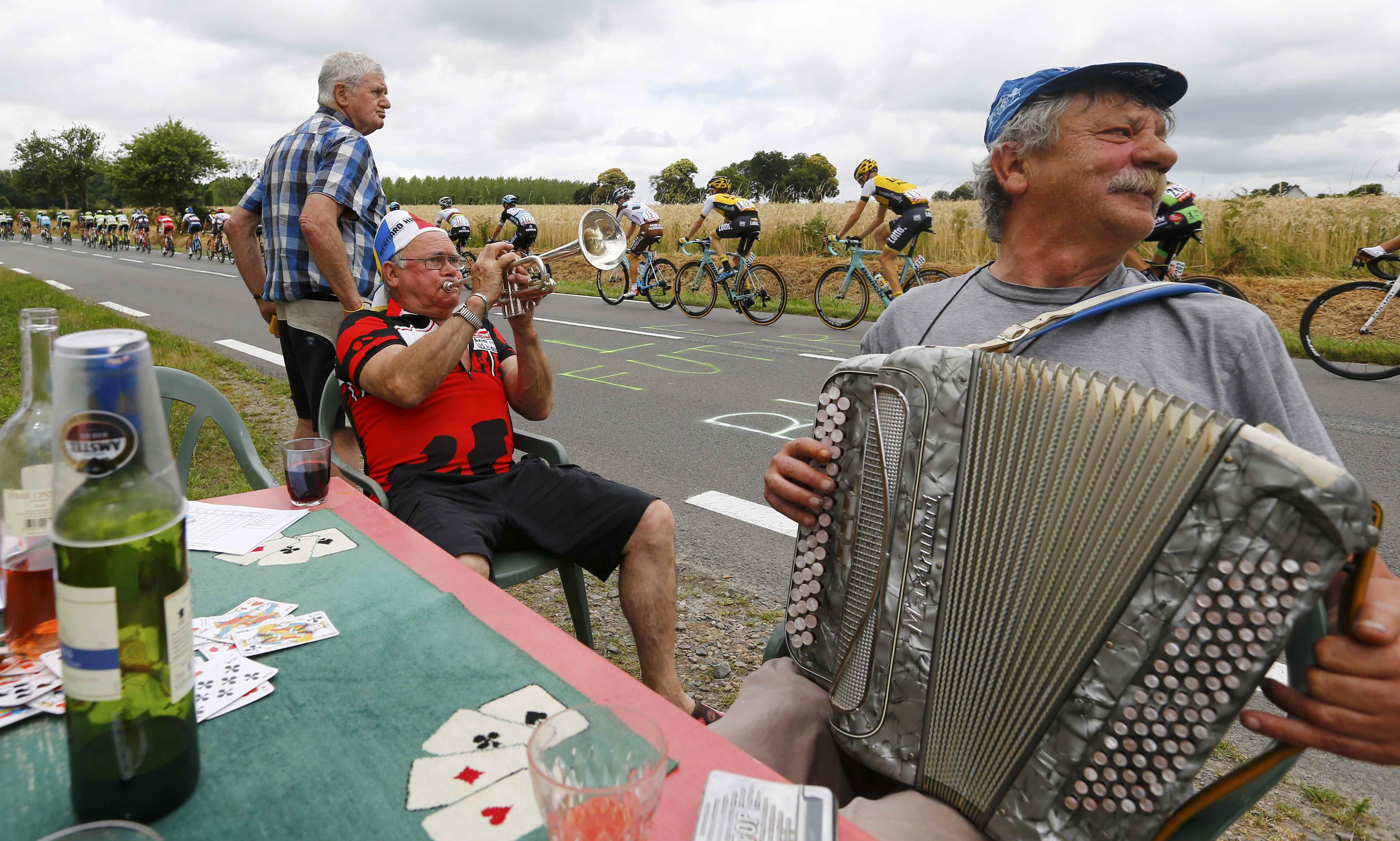 Cycling supporters play instruments as riders pass by during the eighth stage of the race from Rennes to Mur-de-Bretagne, France on July 11, 2015.