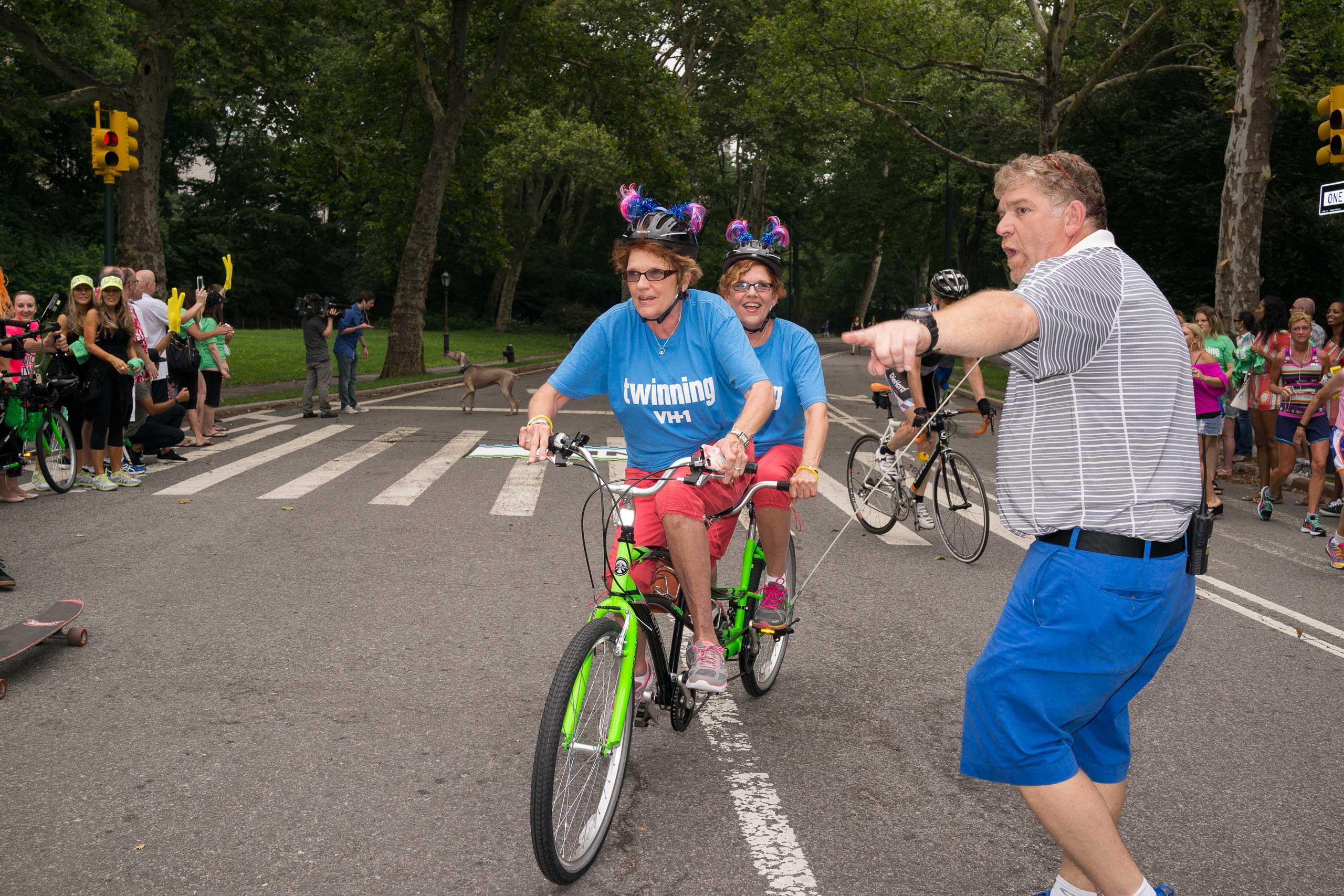 Twins ride over the finish line as hundreds of twins ride tandem bikes in an attempt to set the record for the most twins ever riding tandem bikes, in Central Park in New York City on July 15, 2015.
