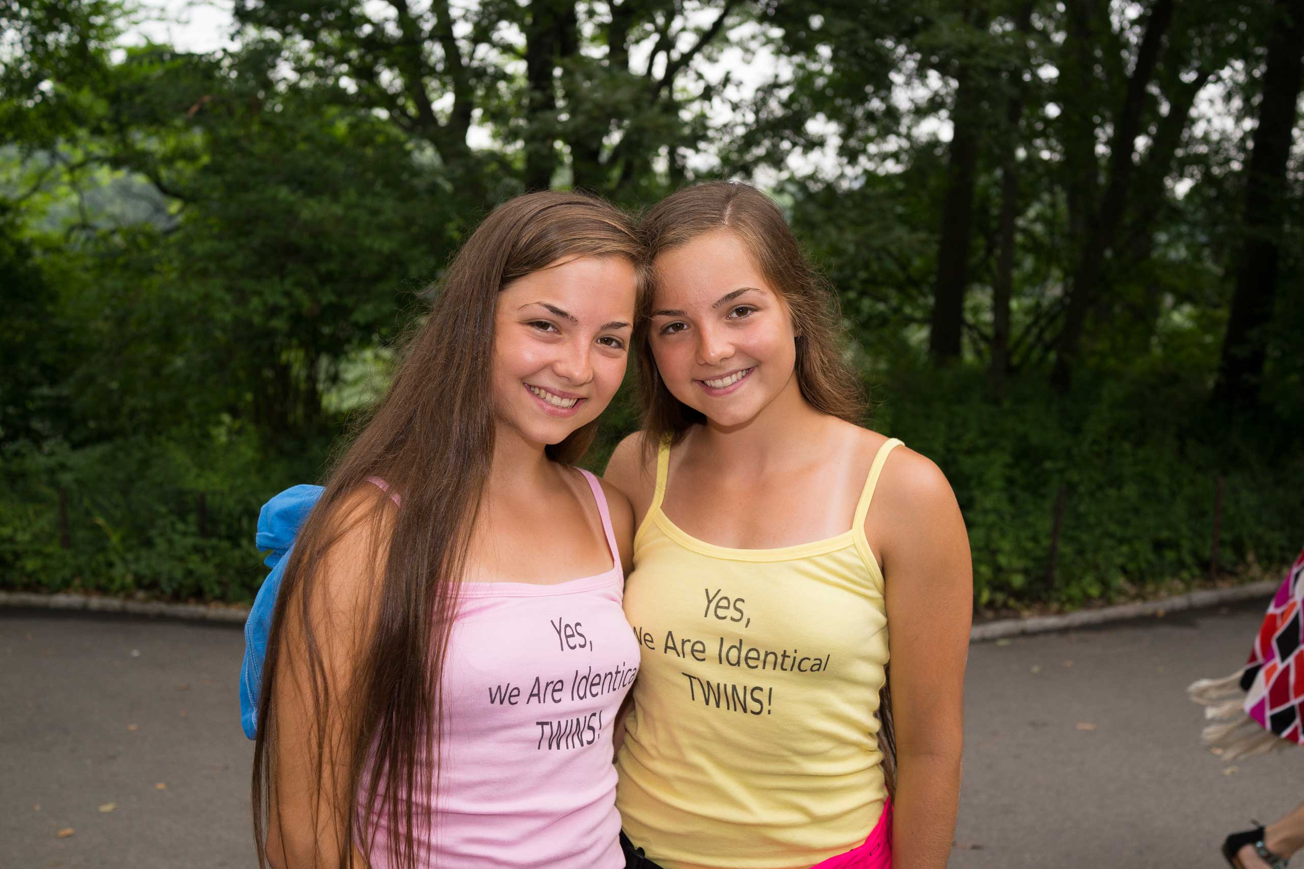 Victoria and Nicole San Filippo pose for a photograph as hundreds of twins ride tandem bikes in an attempt to set the record for the most twins ever riding tandem bikes, in Central Park in New York City on July 15, 2015.