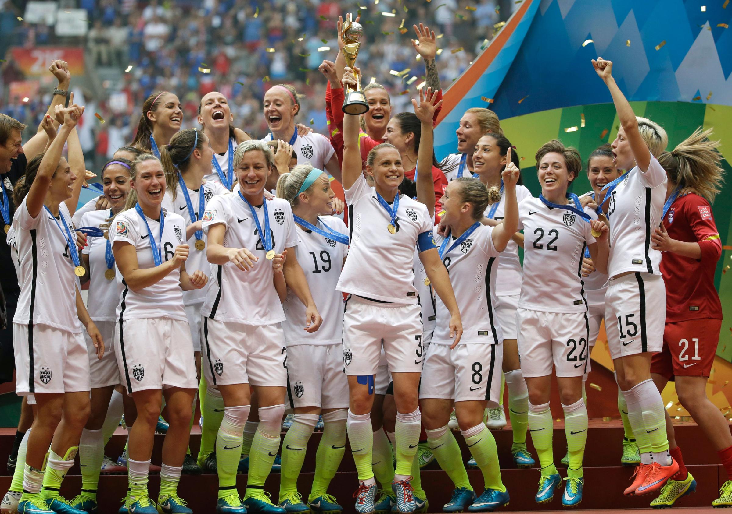 The United States Women's National Team celebrates with the trophy after they beat Japan 5-2 in the FIFA Women's World Cup soccer championship in Vancouver, British Columbia, Canada, Sunday, July 5, 2015. (AP Photo/Elaine Thompson)
