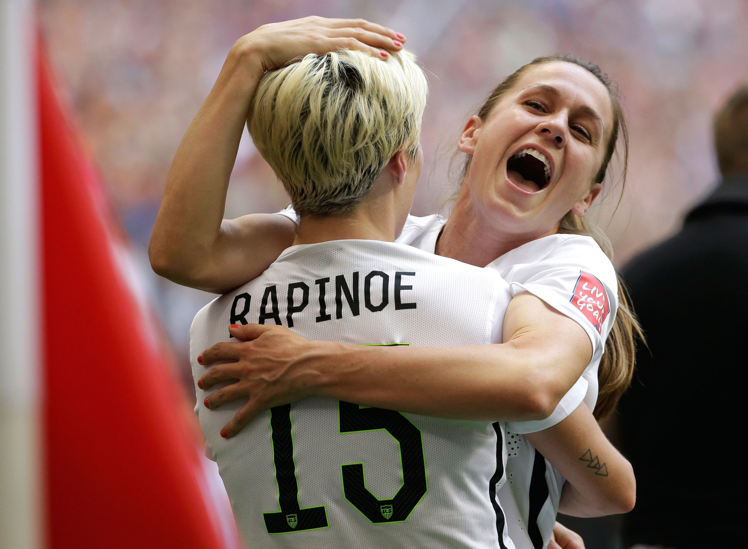 Heather O'Reilly hugs Megan Rapinoe after the U.S.A. beat Japan 5-2 in the final match of the 2015 FIFA Women's World Cup at the BC Place Stadium in Vancouver on July 5, 2015.