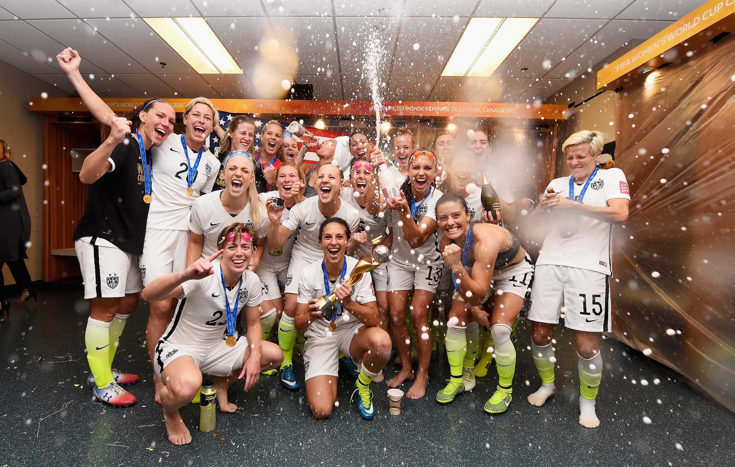 Carli Lloyd of USA celebrates with the trophy and her team mates in the locker room after winning the FIFA Women's World Cup 2015 Final between USA and Japan at BC Place Stadium on July 5, 2015 in Vancouver, Canada. (Lars Baron—Getty Images)