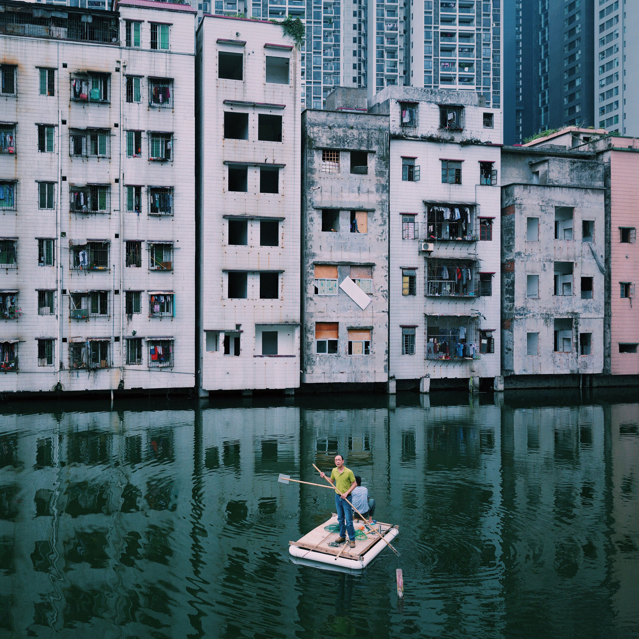Two men fish in a pond in Xian Village, which is in the city center of Guangzhou, China. A conflict between locals and real estate developers lasts for more than seven years because of the uneven compensation and the corruption of Xian village leaders. (Yuyang Liu)