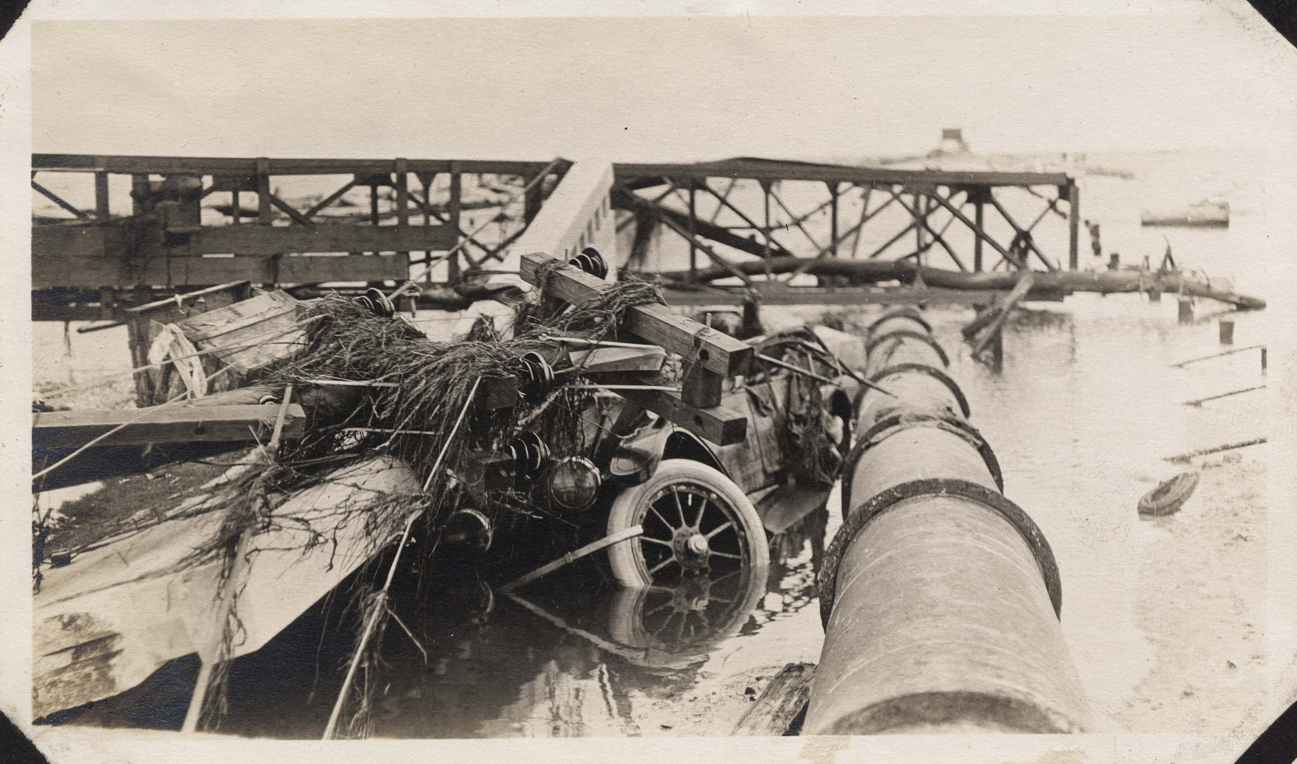 Wrecked semaphore bridge, pipe, poles. Car caught on Causeway during collapse (occupants made it to VA Pt. signal tower and survived).