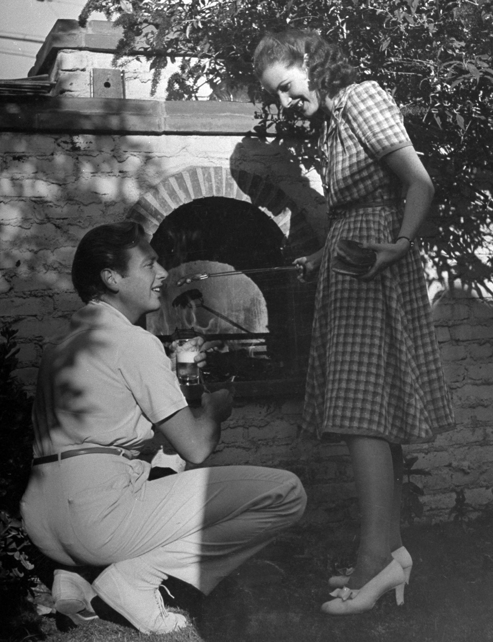Actress Maureen O'Hara and Rand Brooks at John Hubbard's barbecue, 1940.