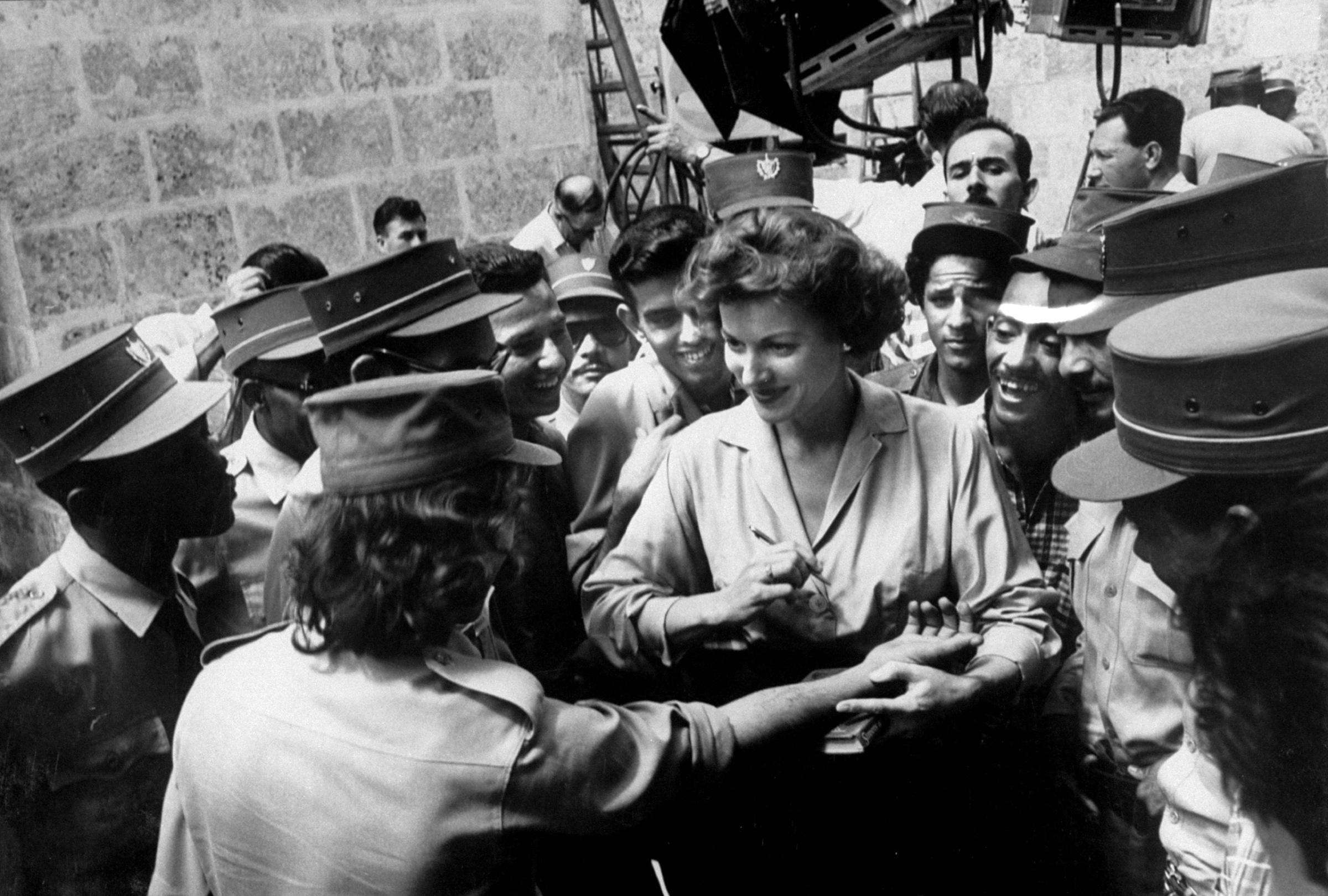 Maureen O'Hara signing autographs while filming "Our Man in Havana," 1959.