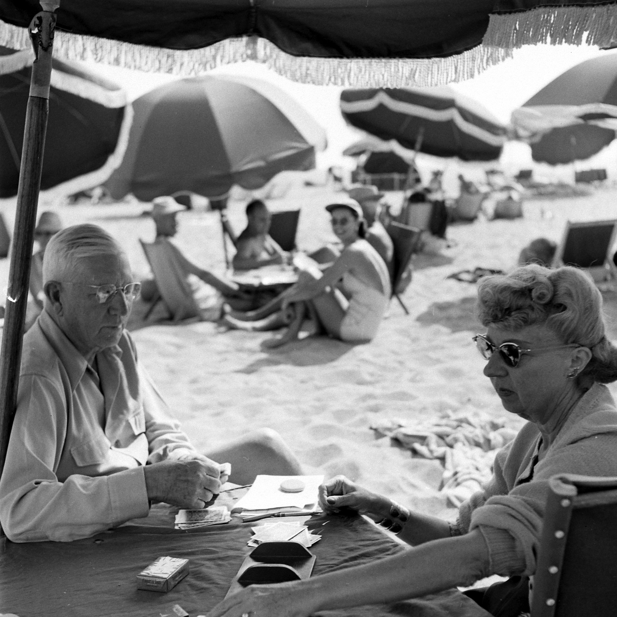 Couple playing cards at Santa Monica Beach, California, 1948.
