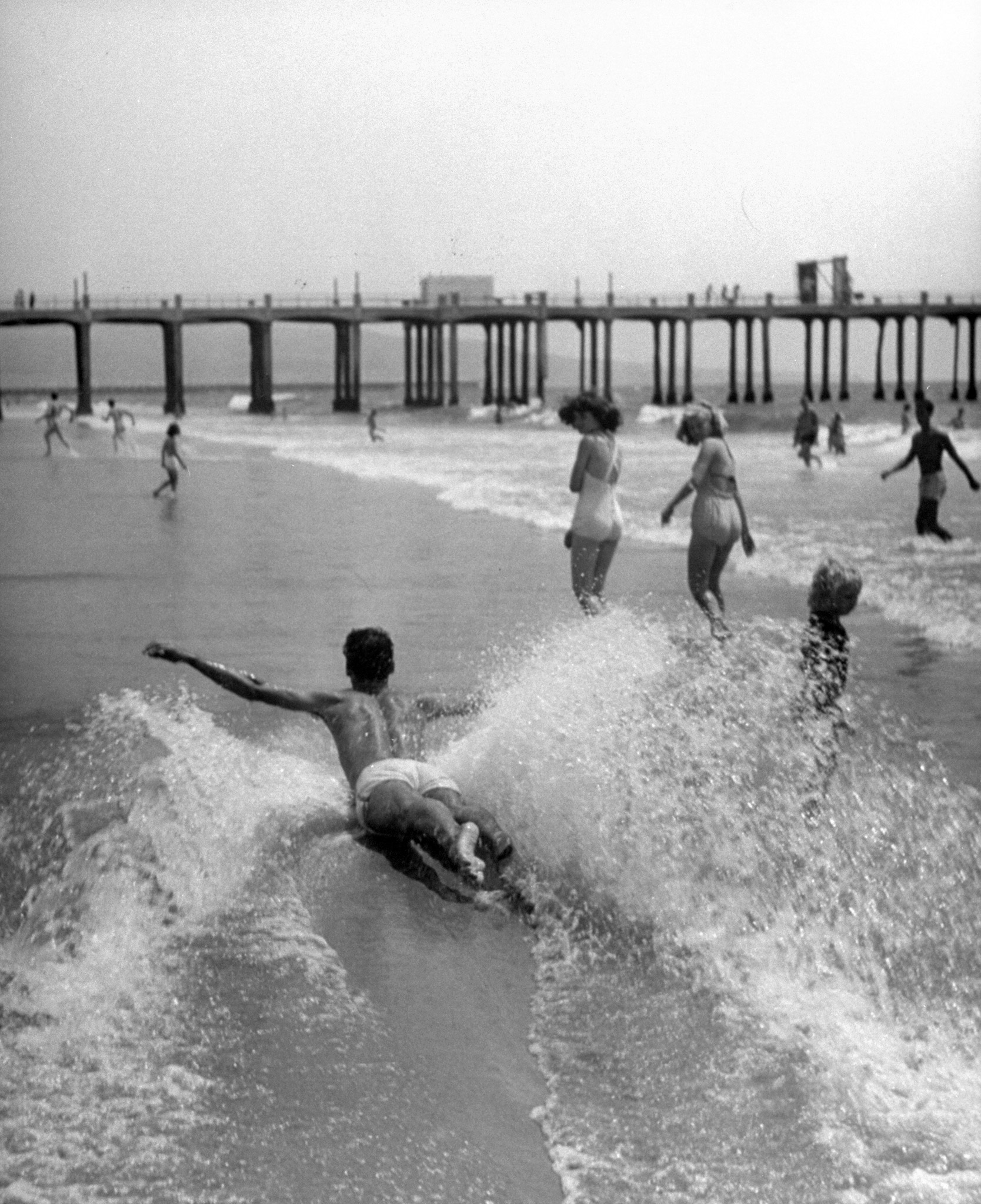 Belly-sliding, a perilous but pleasant sport, is demonstrated by an expert at California's Hermosa Beach.