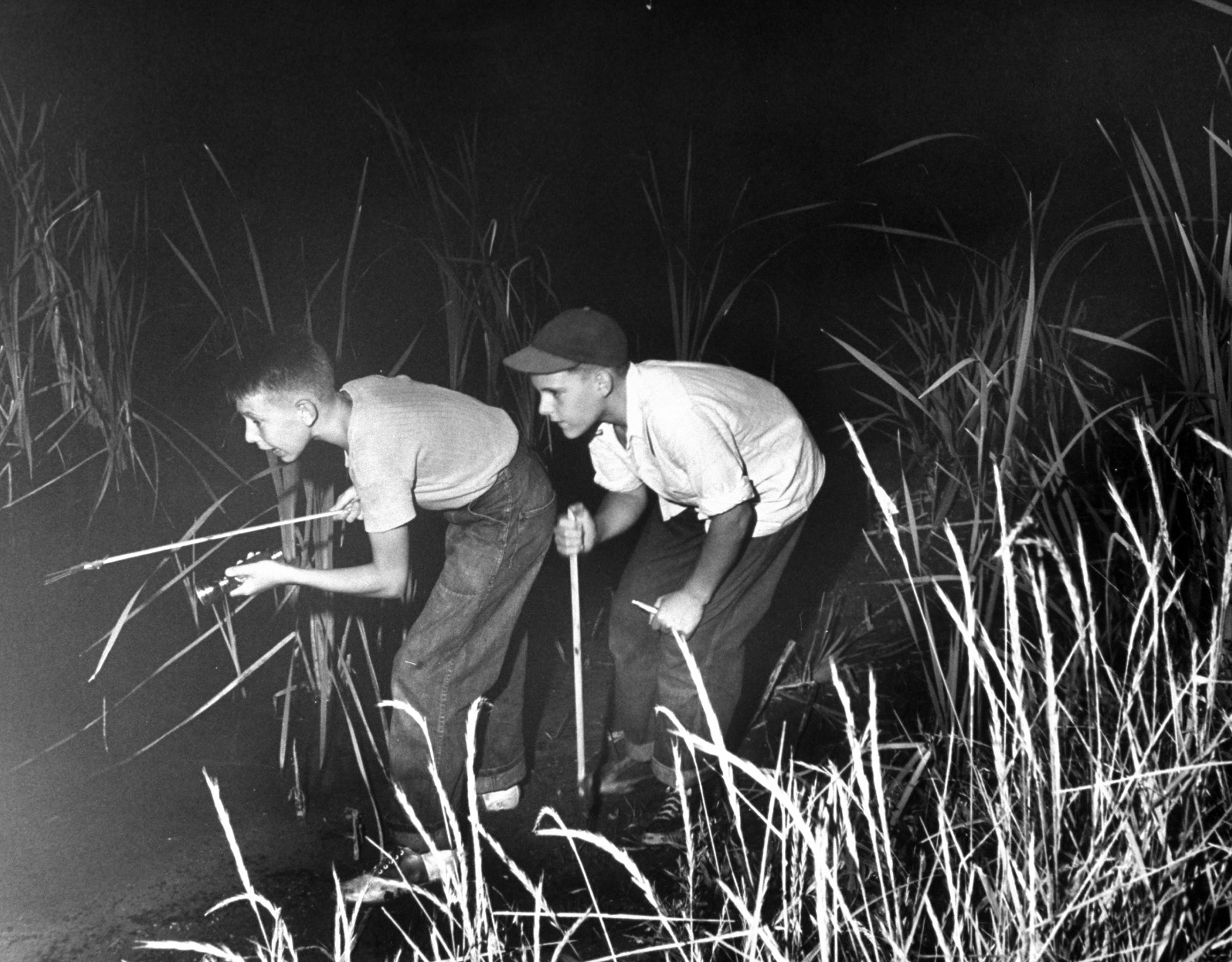 Frog gigging in the pond behind his house, Pres carries a spear and flashlight. "Hey, Mac, there's one," he yells. But when he caught it, it turned out to be a crawfish.