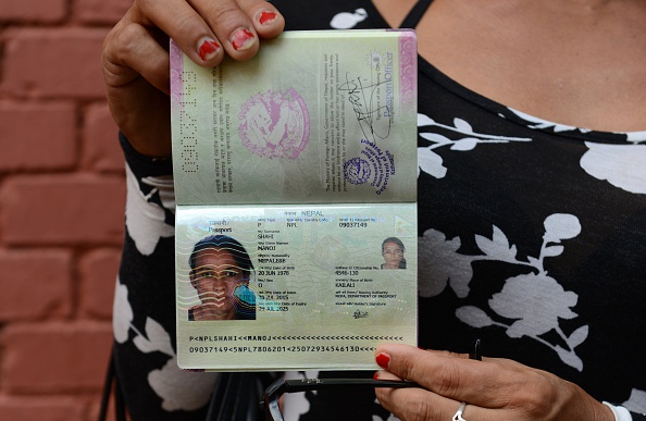 Nepalese transgender and the first recipient of a Nepalese transgender passport, Monica Shahi from Kailali district displays her new passport with "O" for other in the document's gender section, in Kathmandu on August 10, 2015 (Prakash Mathema —AFP/Getty Images)