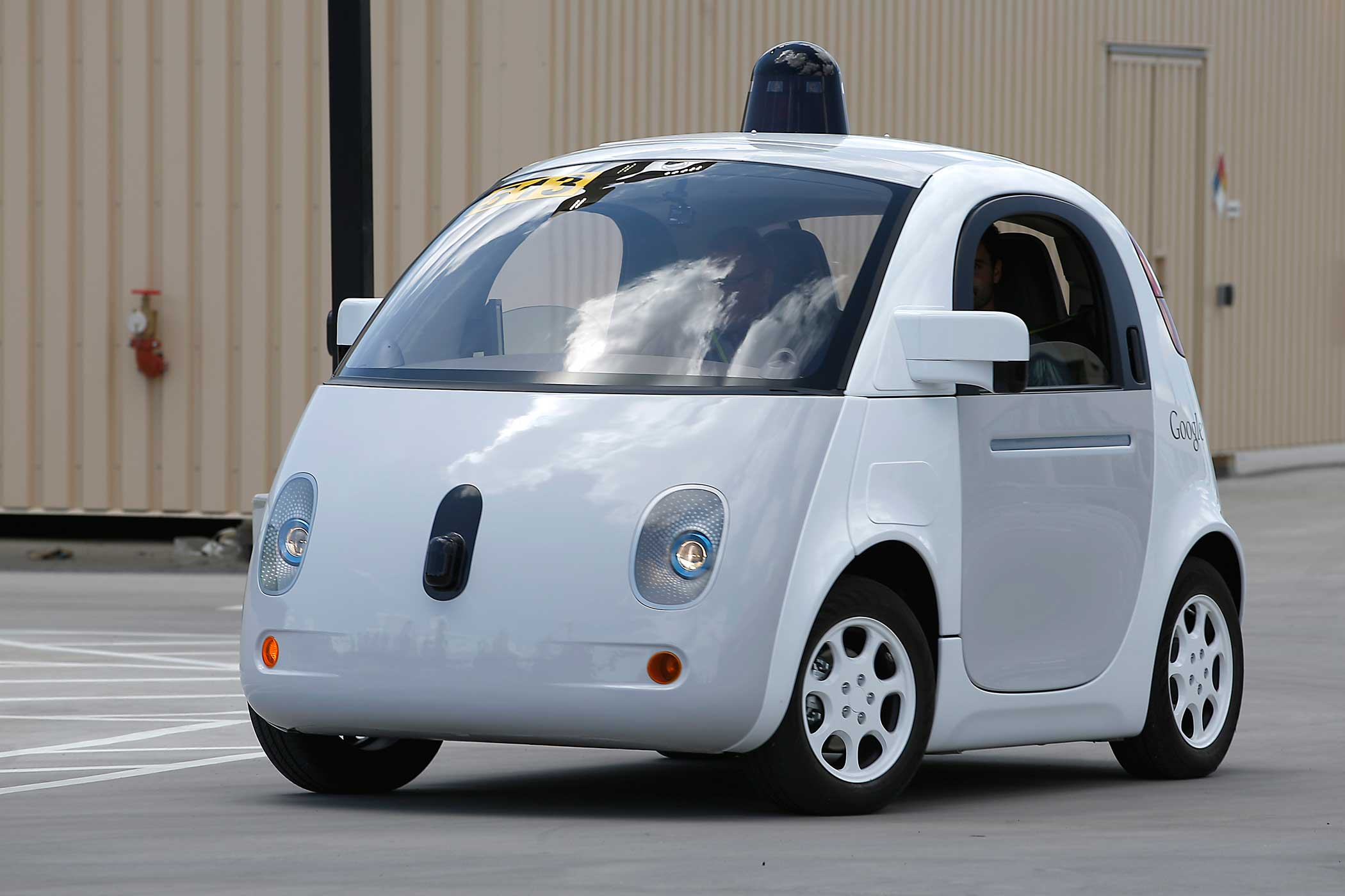 Google's new self-driving prototype car drives around a parking lot during a demonstration at Google campus on May 13, 2015, in Mountain View, Calif.