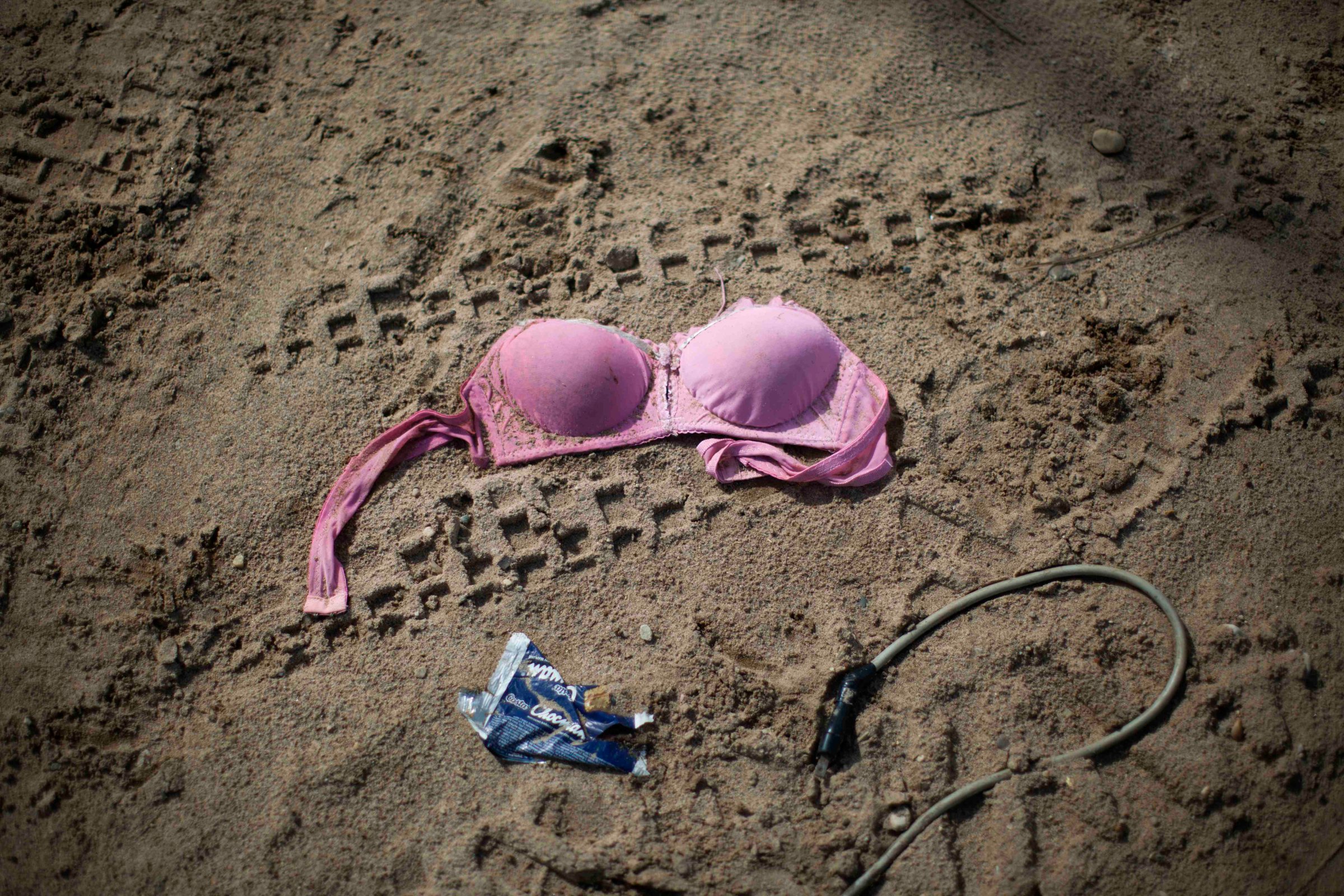 FILE - In this Friday, May 16, 2014 file photo, a discarded bra lies on the ground outside an informal bar that allegedly employed sex workers after a government raid on the illegal mining camp in La Pampa in the Madre de Dios region of Peru. Amnesty International approved a controversial policy Tuesday, Aug. 11, 2015 to endorse the de-criminalization of the sex trade, rejecting complaints by womens rights groups who say it is tantamount to advocating the legalization of pimping and brothel owning. (AP Photo/Rodrigo Abd, File)