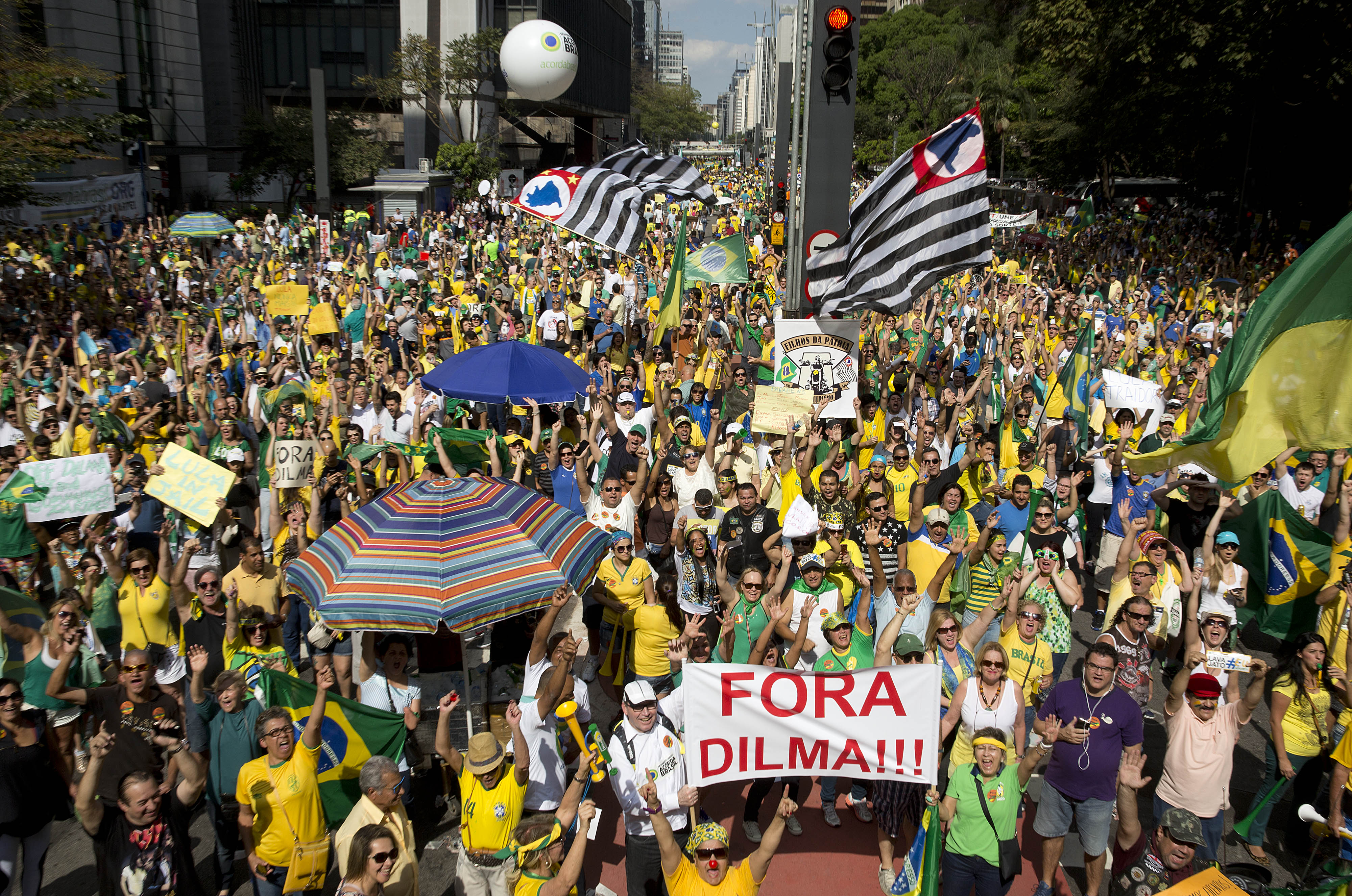 Demonstrators hold a sign that reads in Portuguese "Dilma out" during a protest demanding the impeachment of Brazil's President Dilma Rousseff in Sao Paulo, Brazil, Aug. 16, 2015 (Andre Penner—AP)