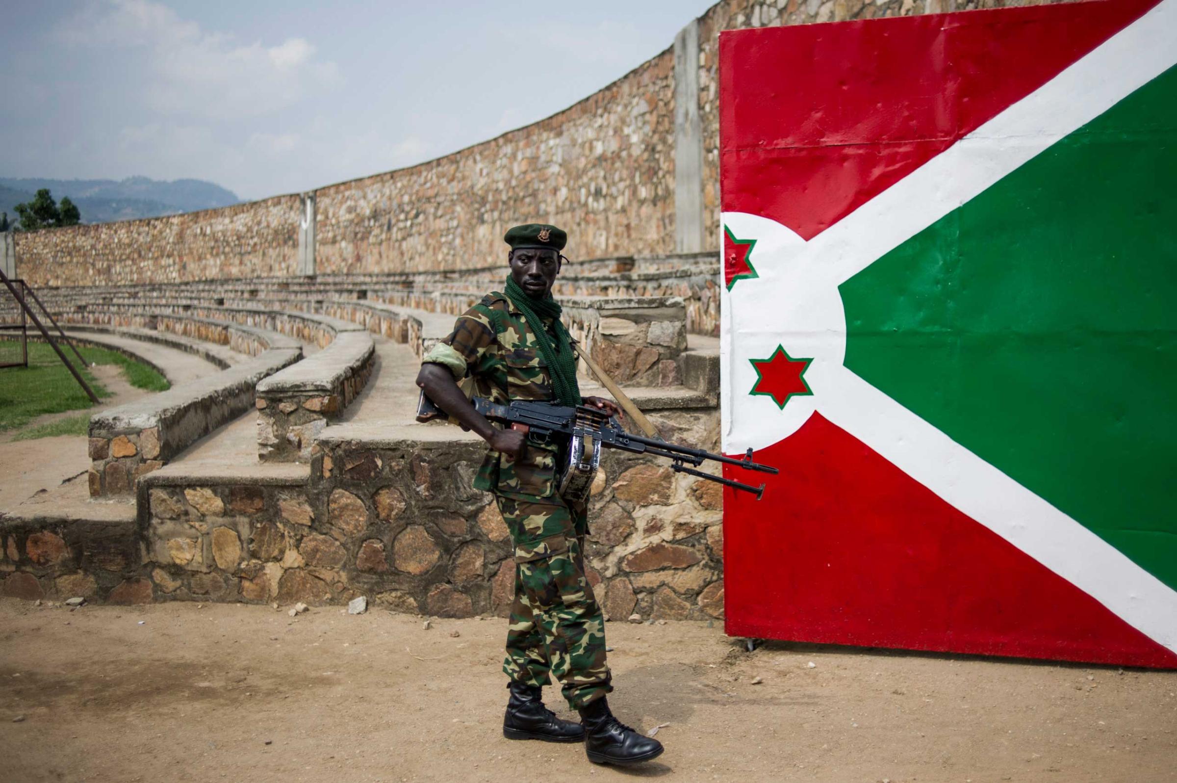 A soldier stands next to a gate painted with the Burundian flag at the Prince Rwagasore Stadium in Bujumbura, Burundi, on June 27, 2015, during rehearsals for Independence Day celebrations on July 1st. Since President Pierre Nkurunziza announced in April that he would stand for re-election, the country has been divided between loyalists and the opposition, and a split in the army has occured following the putsch attempt of mid-May.