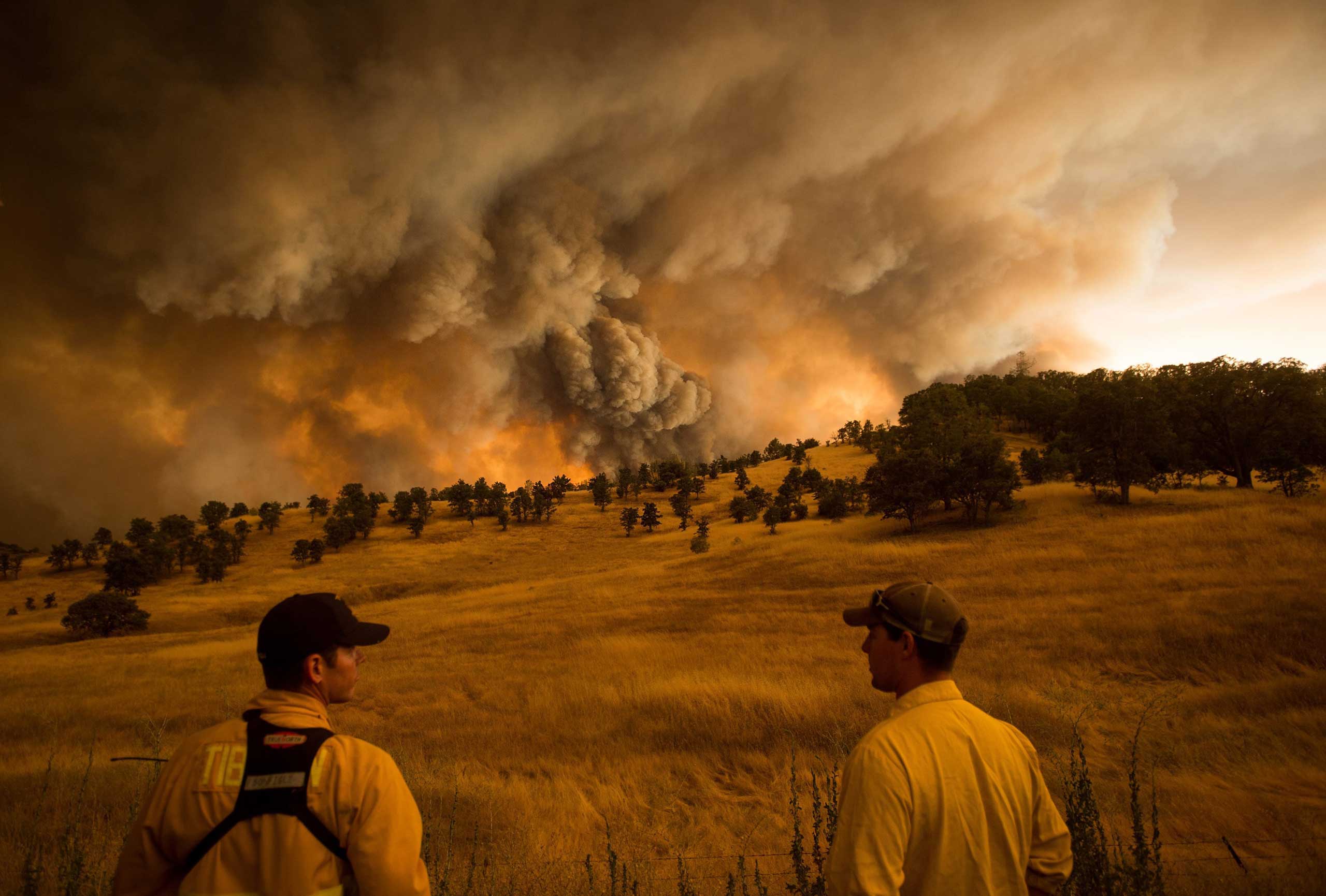 Firefighters watch as the Rocky fire burns near Clearlake, Calif. on Aug. 1, 2015.