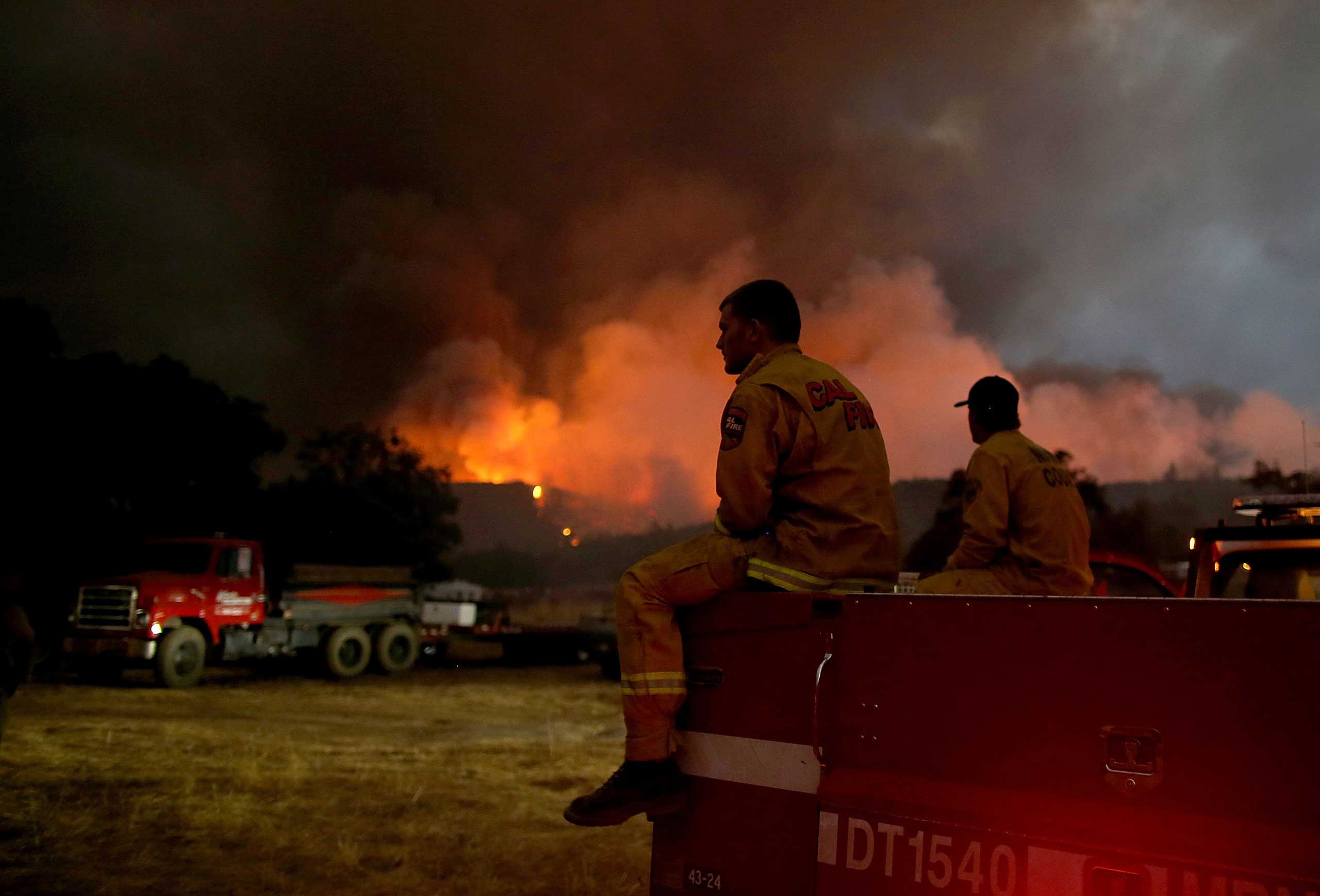 Cal Fire firefighters take a break from battling  the Rocky Fire in Lower Lake, Calif. on July 30, 2015.