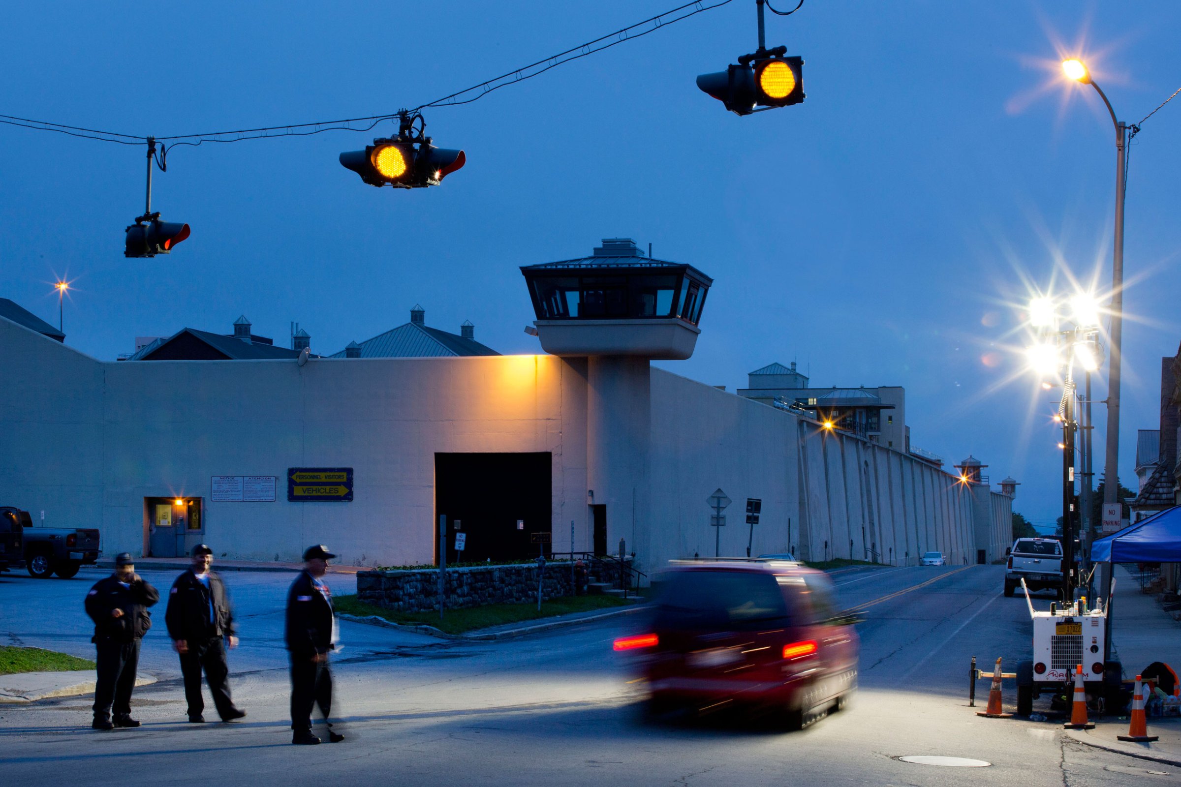 FILE - In this June 15, 2015, file photo, corrections officers watch an intersection in front of Clinton Correctional Facility in Dannemora, N.Y. David Sweat and Richard Matt escaped from the prison June 6. Sweat was captured on Sunday, June 28; Matt was shot and killed Friday June 26. (AP Photo/Mark Lennihan, File)
