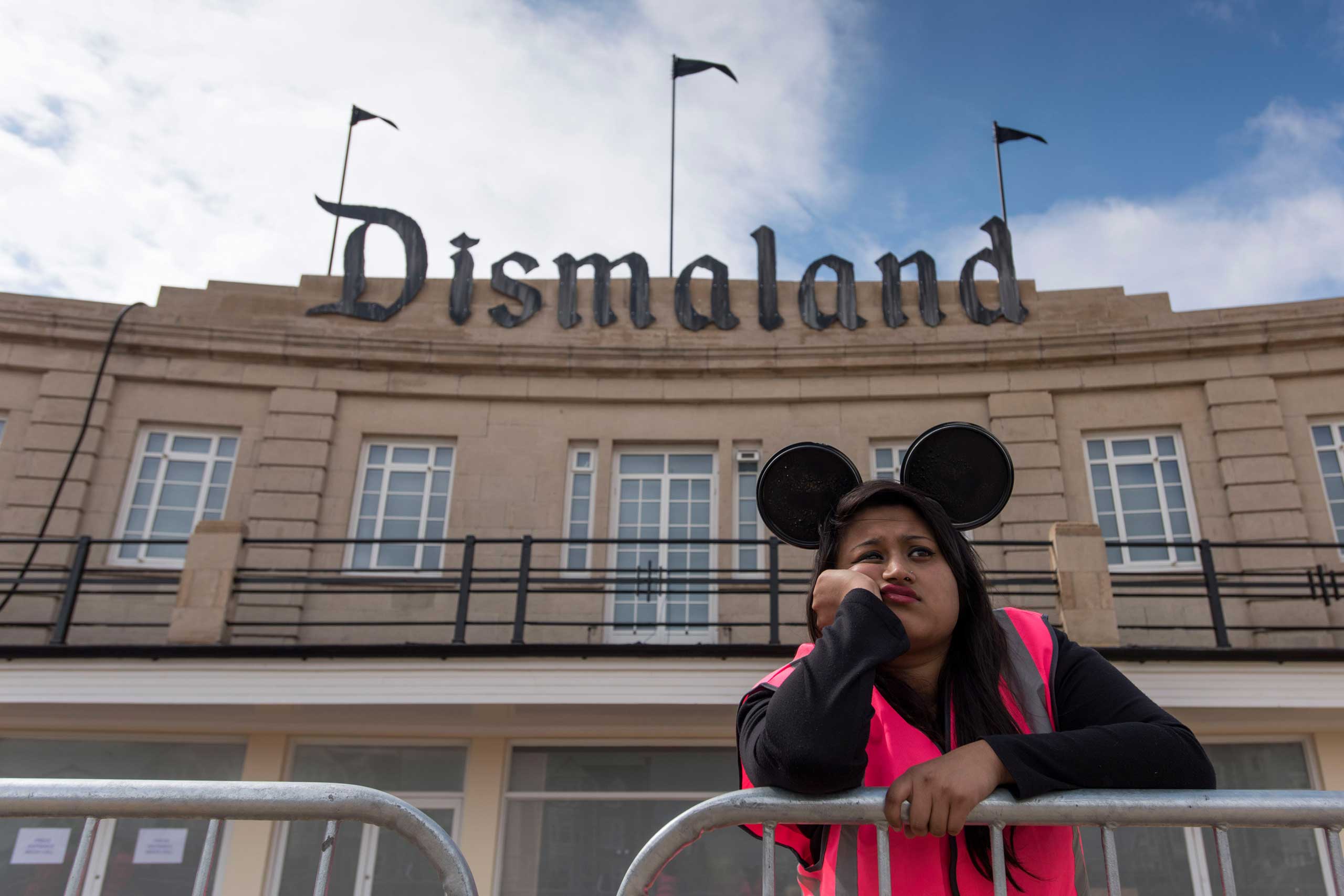 A steward is seen outside Bansky's 'Dismaland' exhibition, which opens tomorrow, at a derelict seafront lido in Weston-Super-Mare, England, on Aug. 20, 2015. (Matthew Horwood—Getty Images)