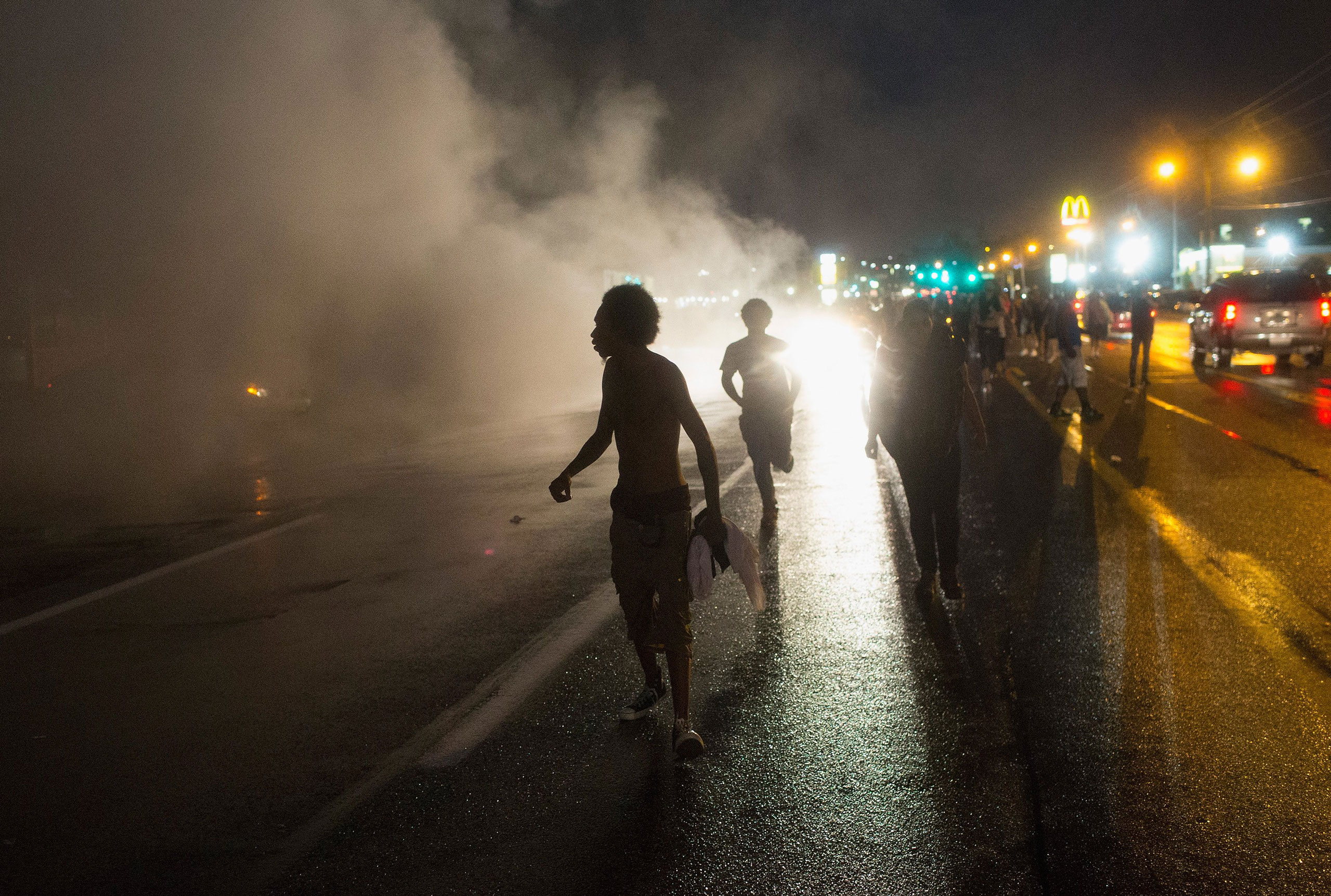 Demonstrators, marking the one-year anniversary of the shooting of Michael Brown, march along West Florrisant Street in Ferguson, Mo., on August 9, 2015.